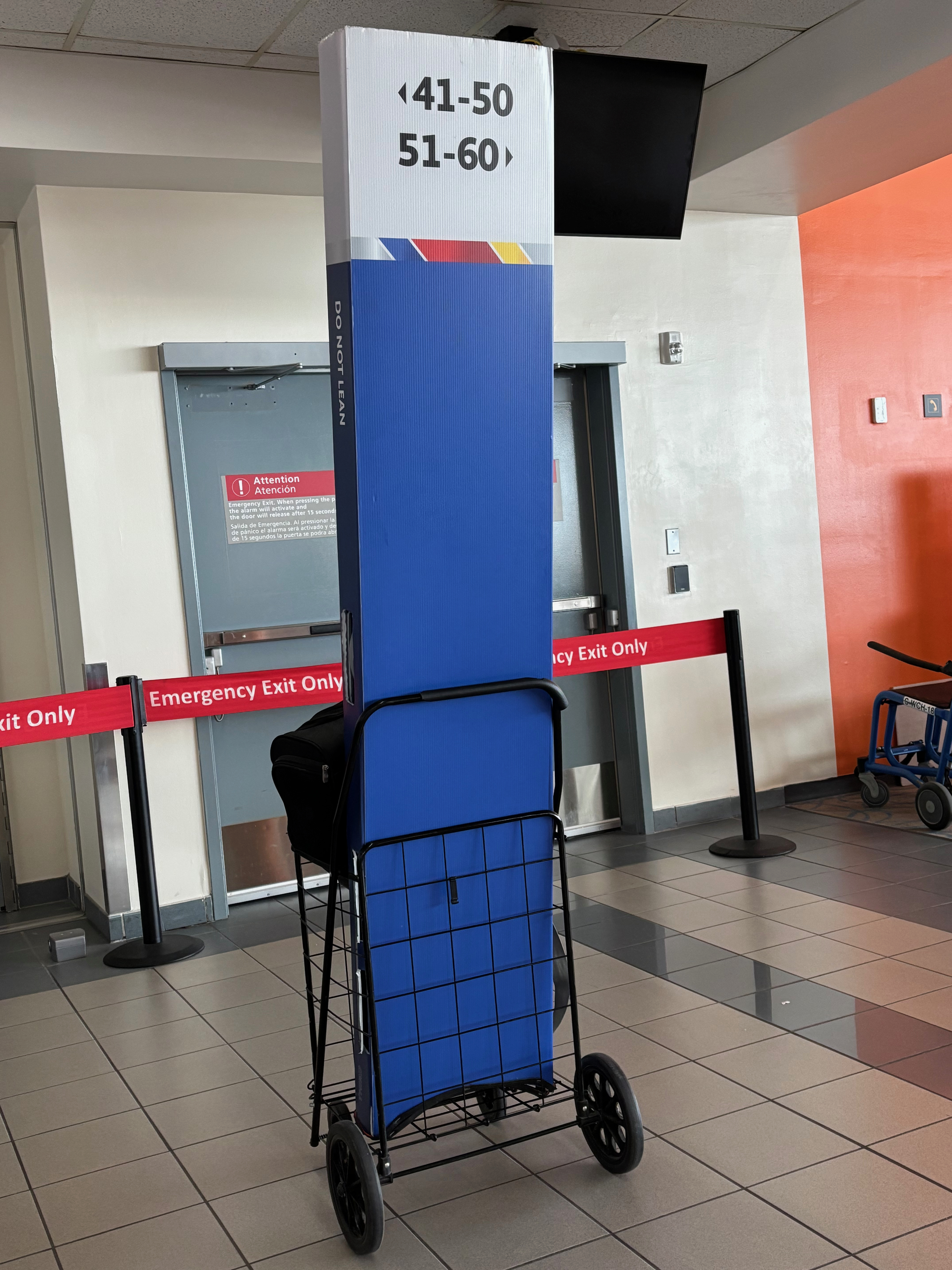 a blue and white sign on a cart