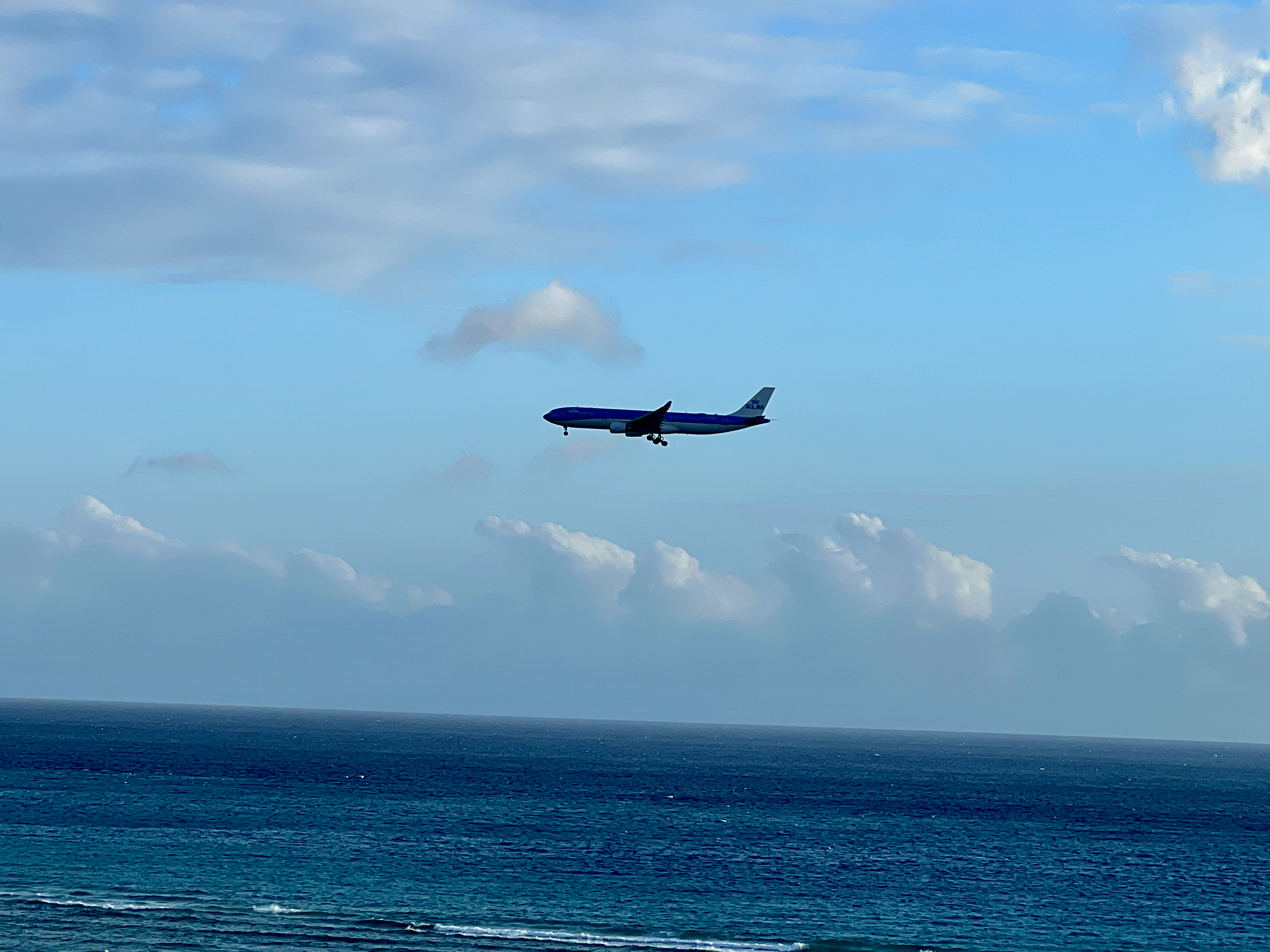 an airplane flying over the ocean