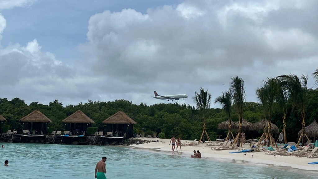 a plane flying over a beach