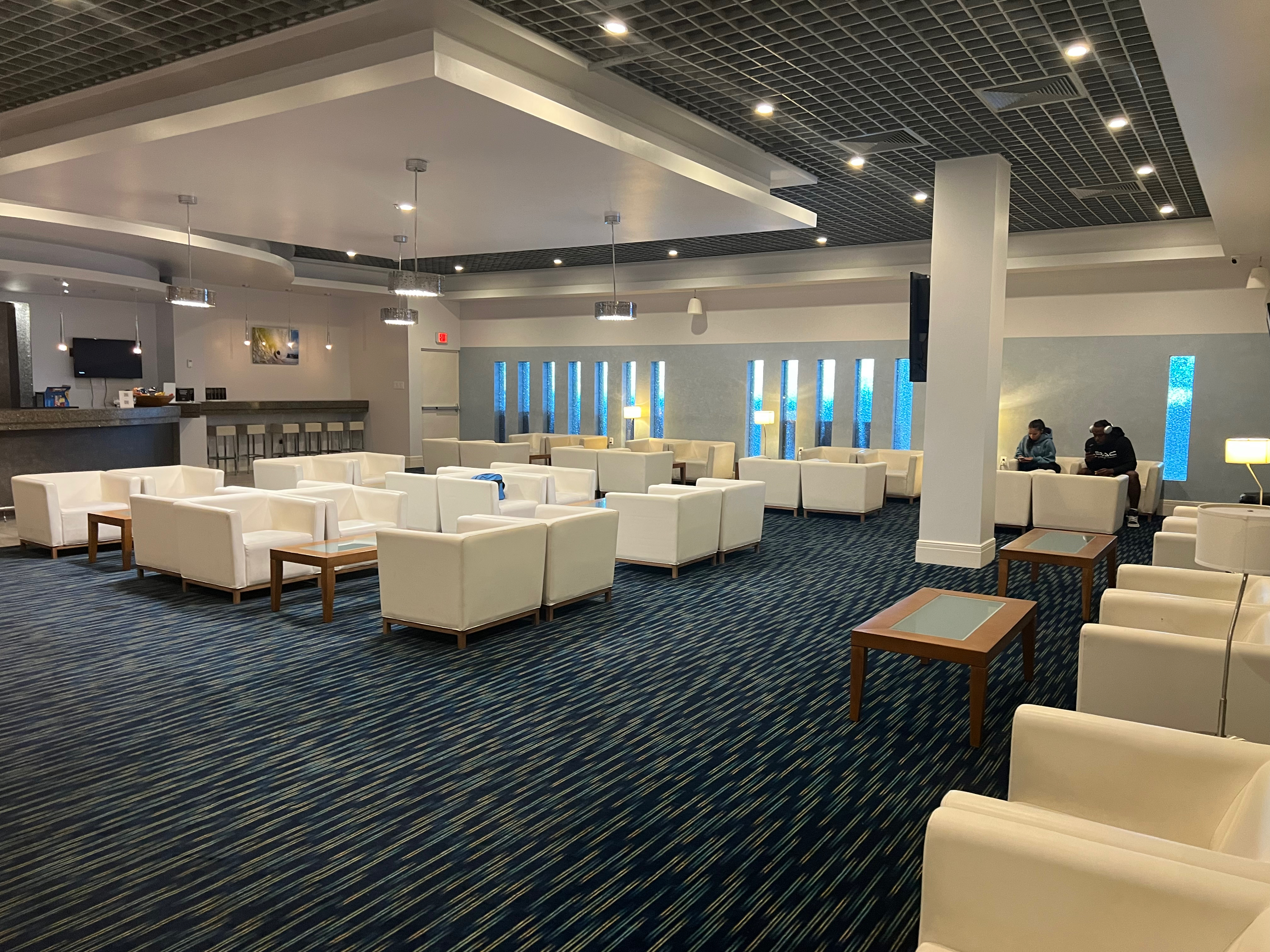 a room with white furniture and tables
