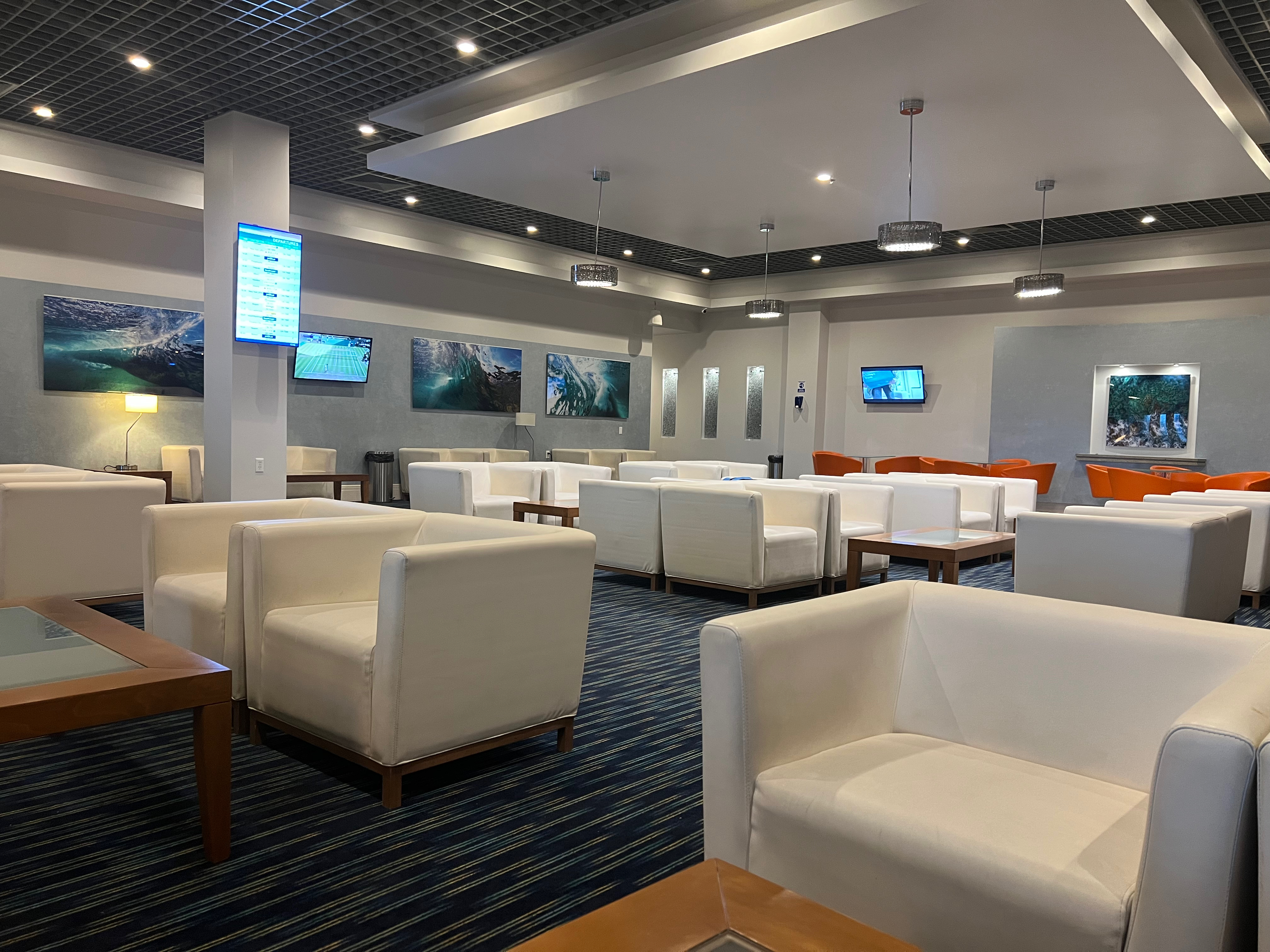 a room with white chairs and a tv