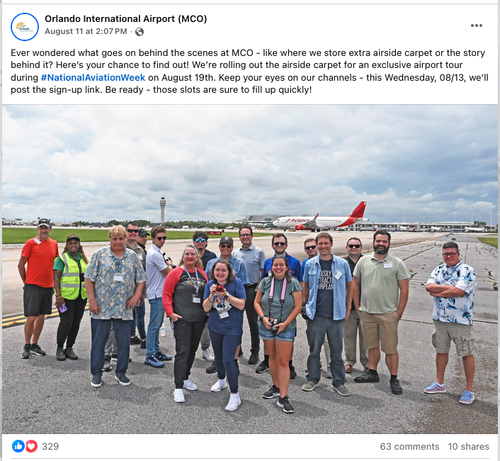 a group of people standing in front of an airplane