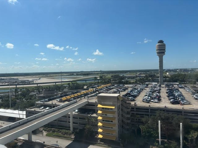 a parking lot with a tower and a bridge