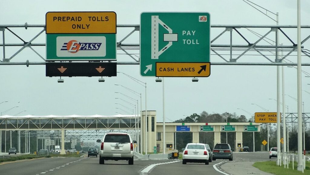 a highway with signs and cars on it