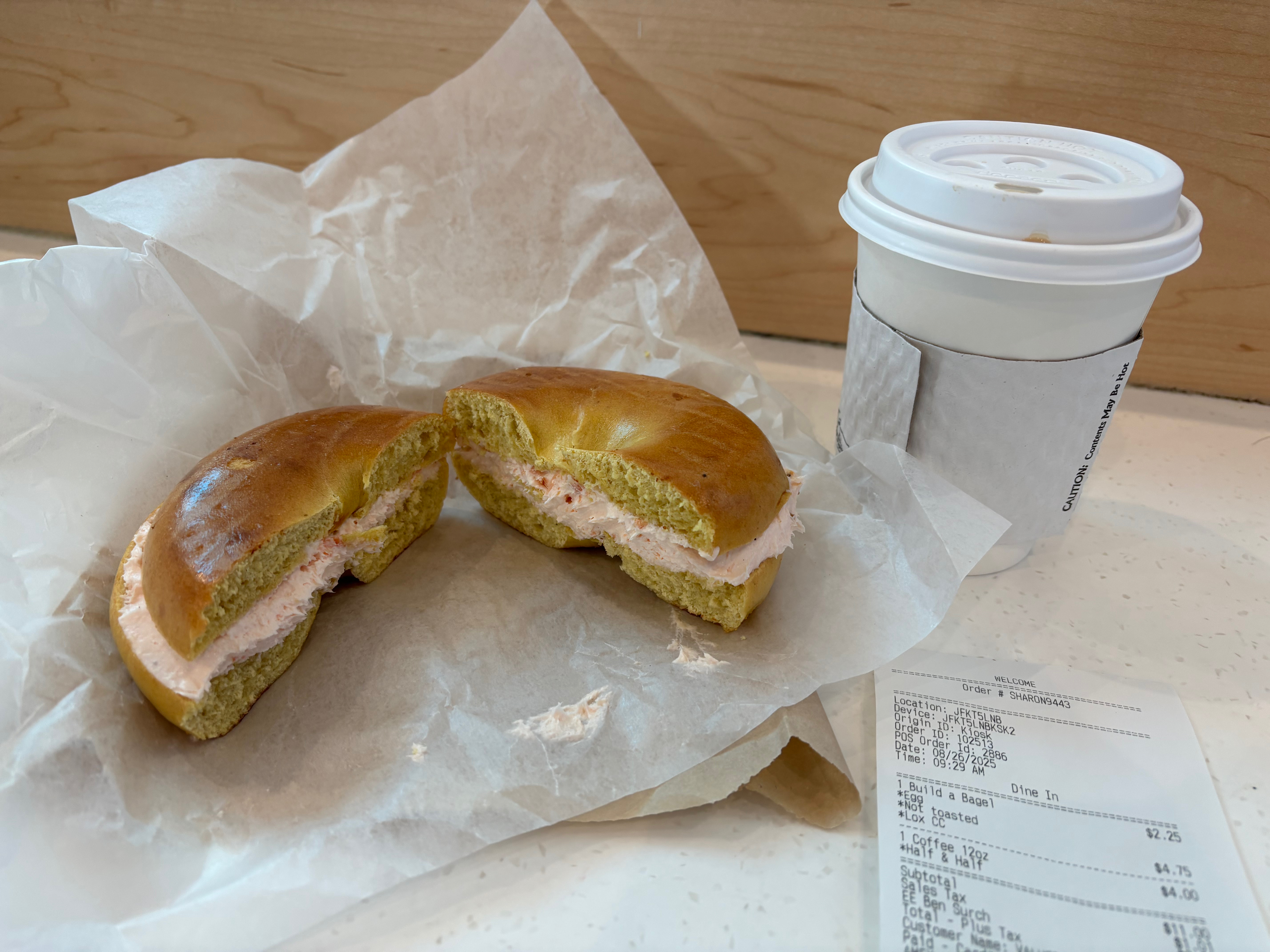 a bagel sandwich with a cup of coffee