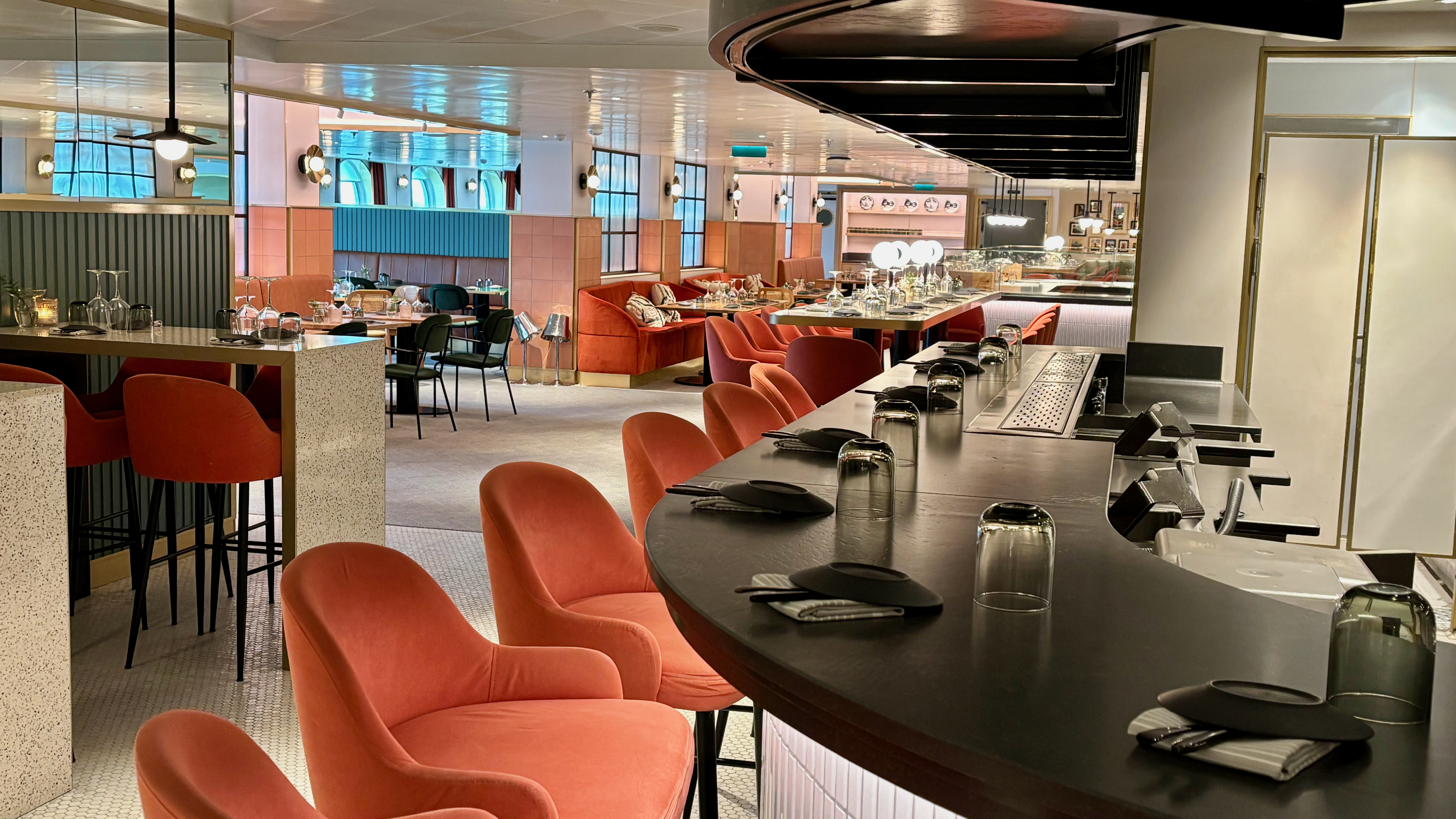 a restaurant with a bar and chairs