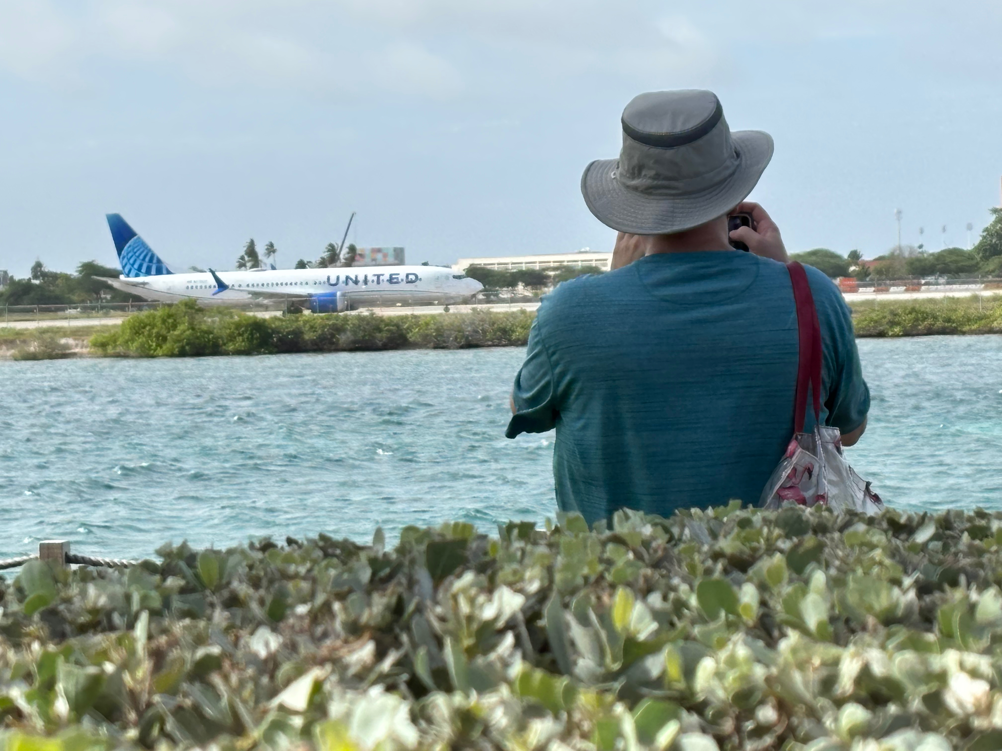 a man taking a picture of an airplane