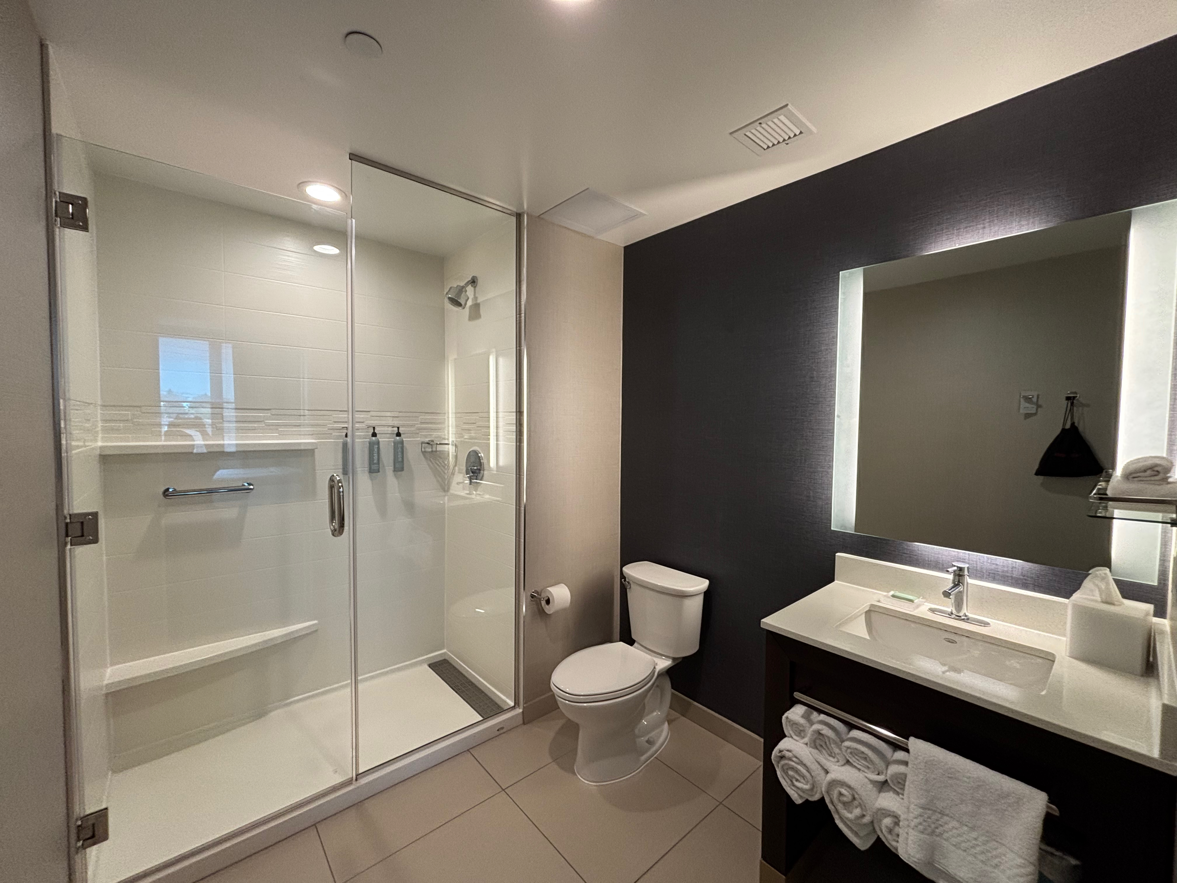 a bathroom with a glass shower and sink