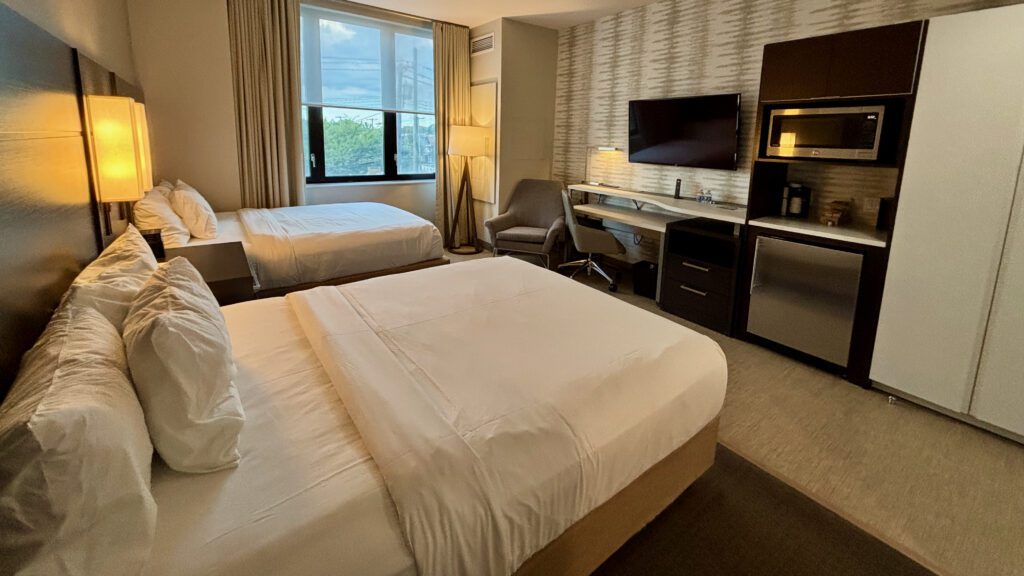 a room with two beds and a desk