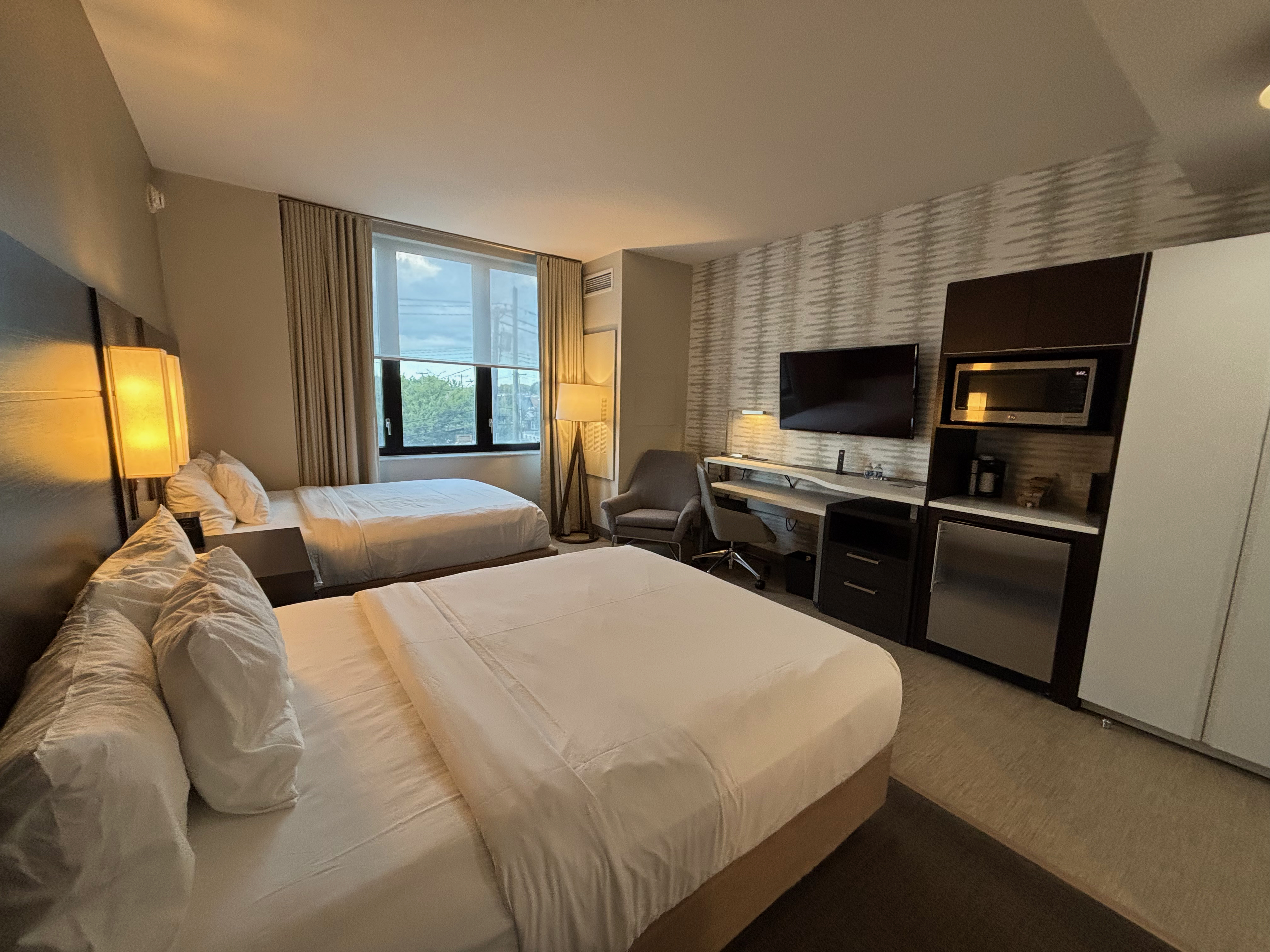 a room with two beds and a desk