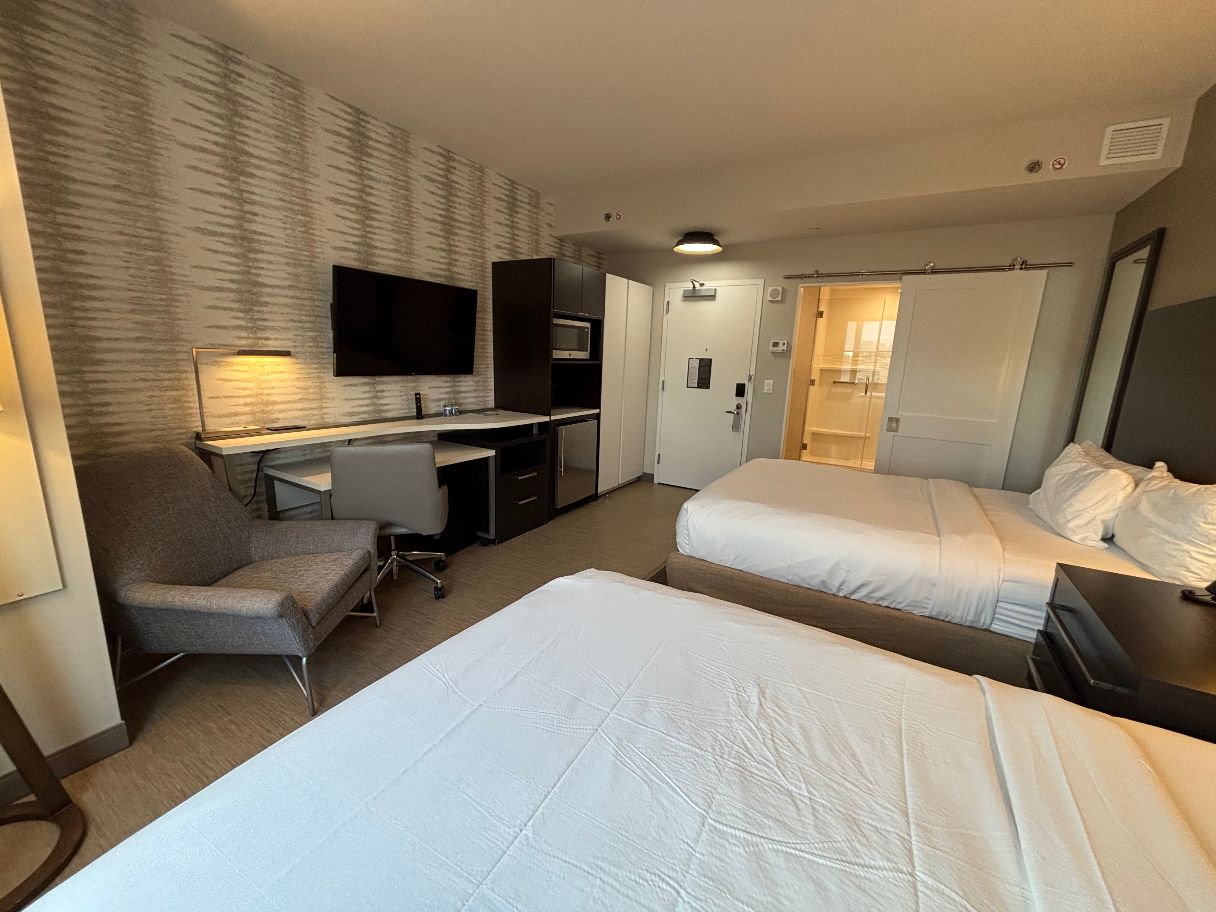 a room with two beds and a desk