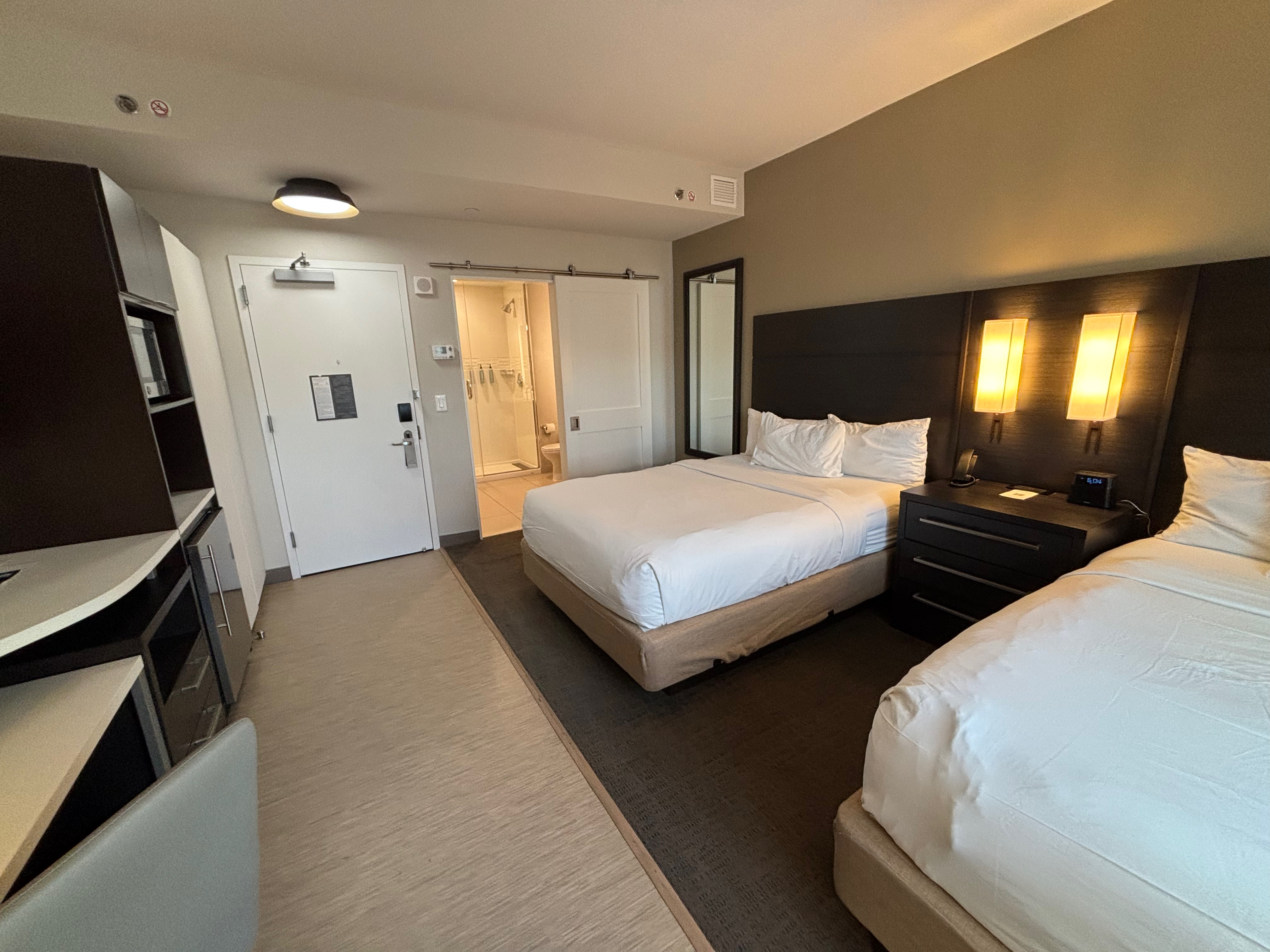 a room with two beds and a tv