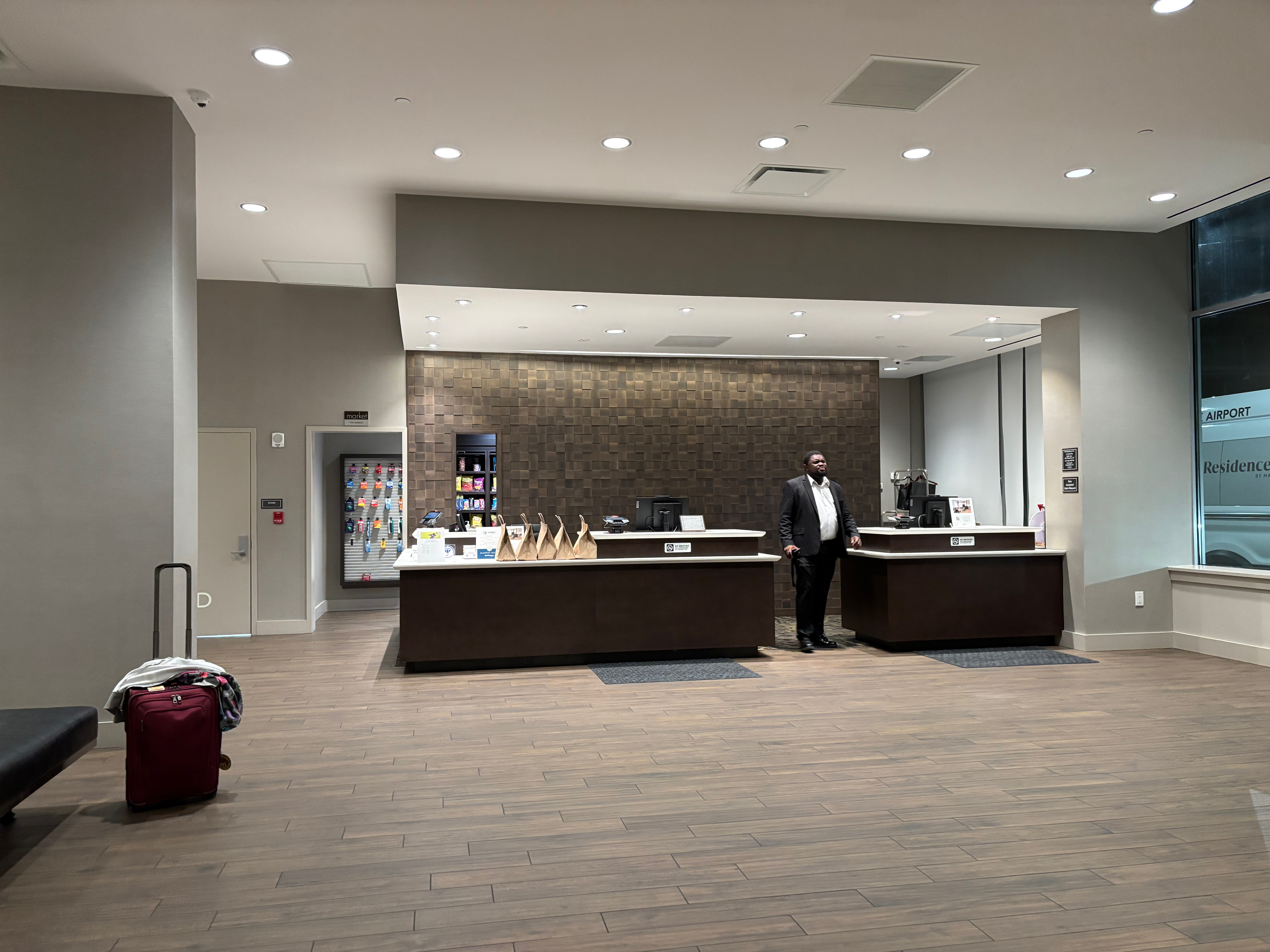 a man standing in front of a counter in a hotel