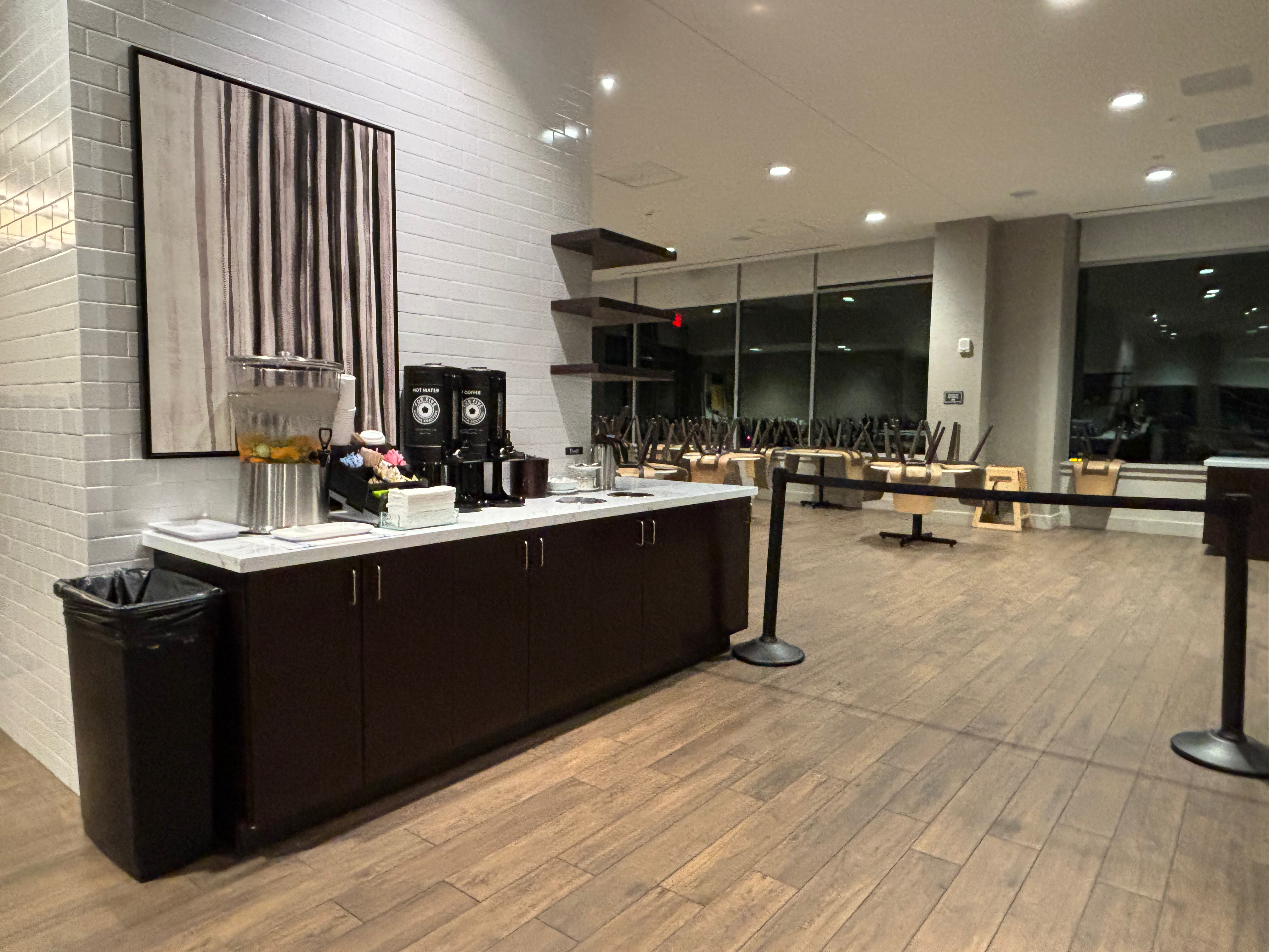 a room with a counter and a table with chairs