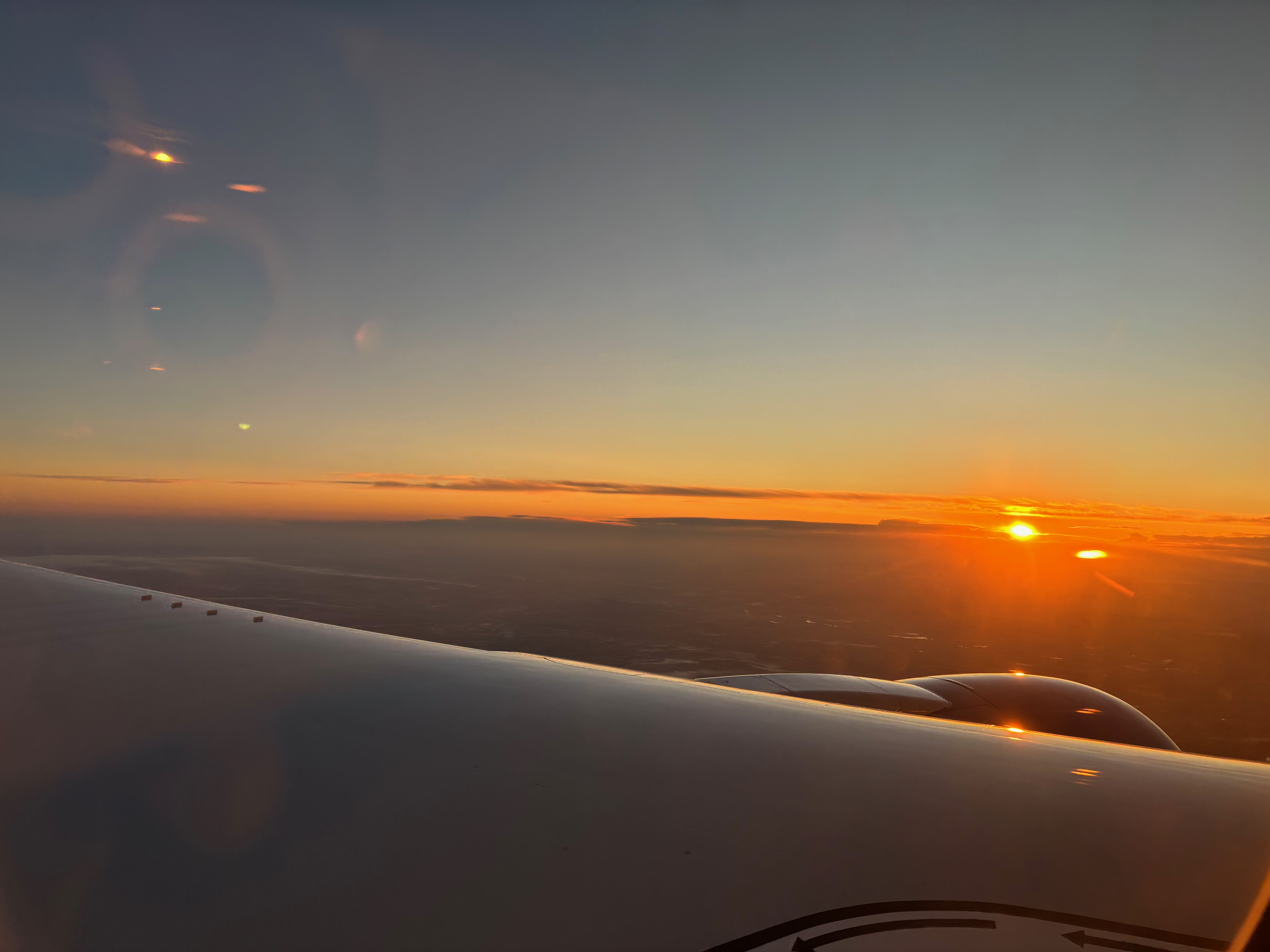 Sunrise wing view approaching London on United Premium Plus