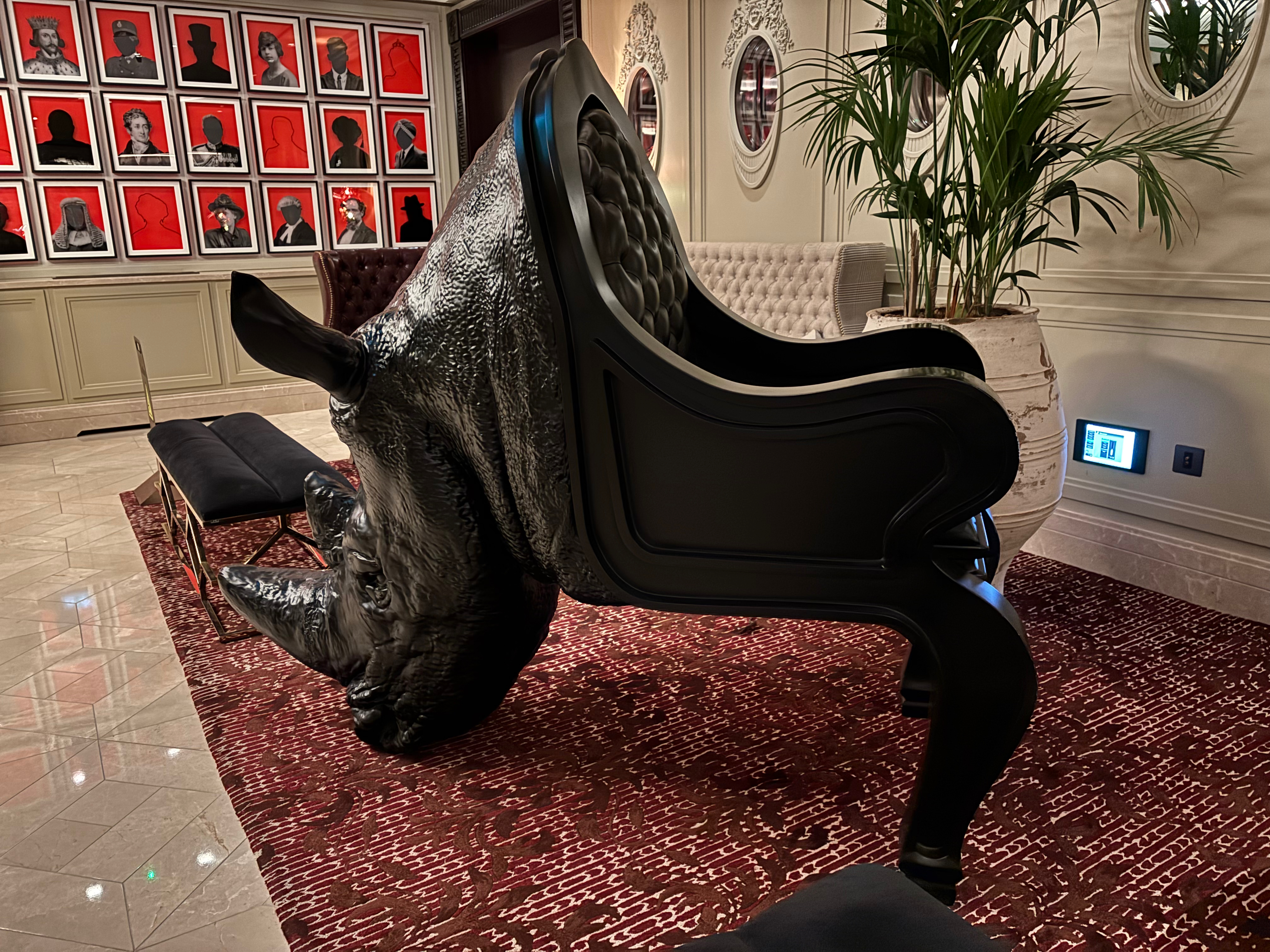 a rhinoceros head on a chair