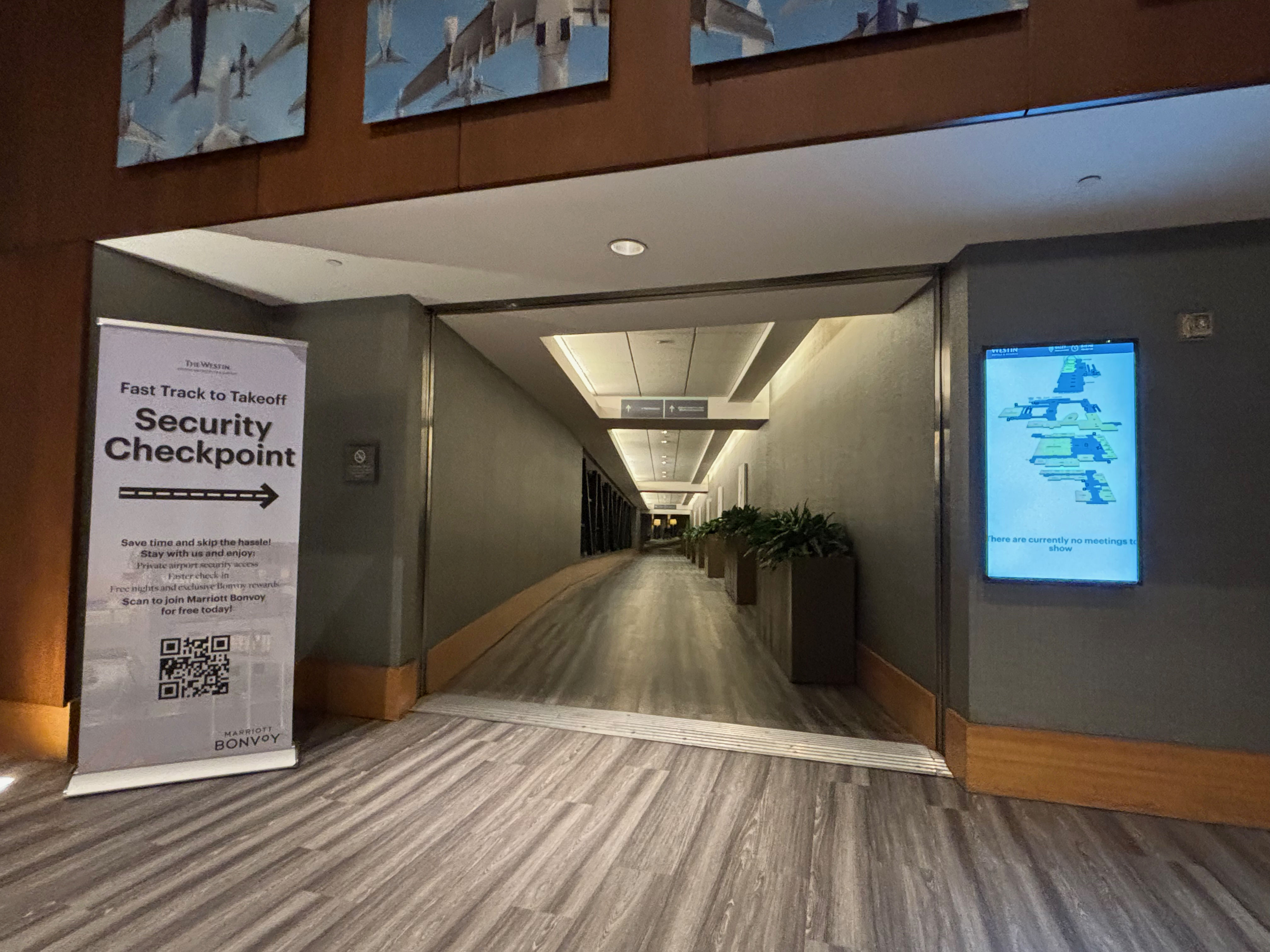 a hallway with a sign and a screen