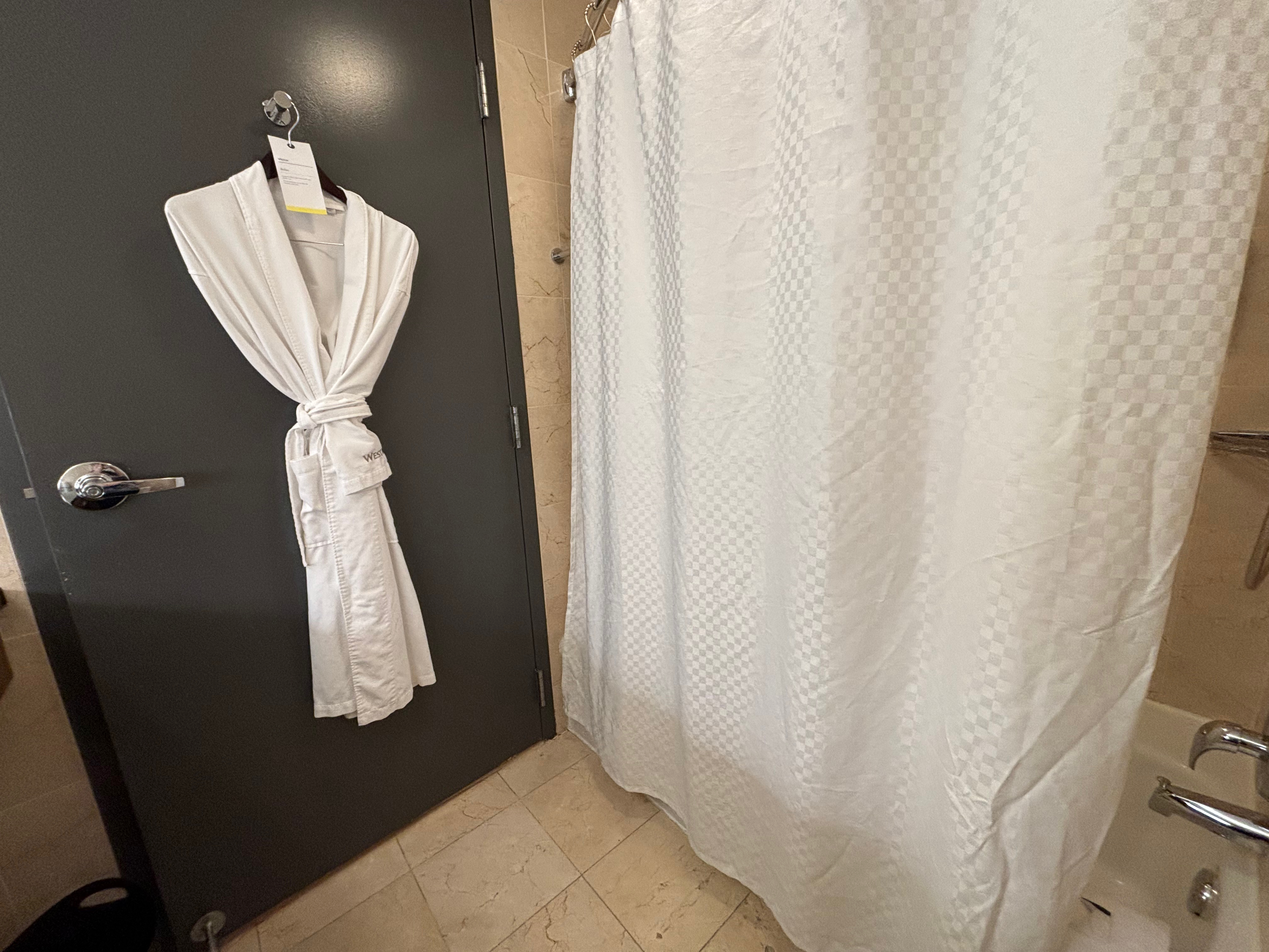 a white bathrobe on a door
