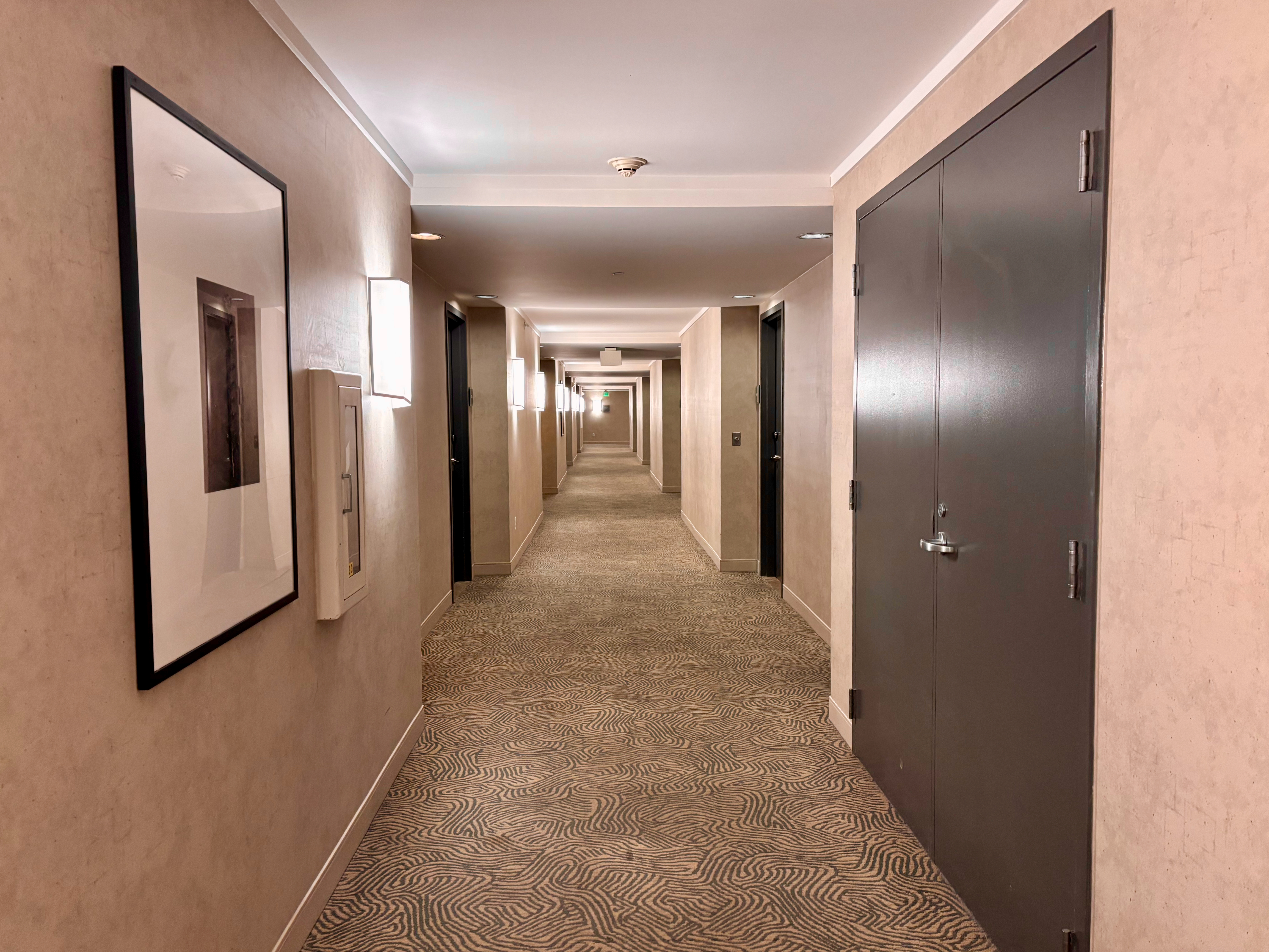 a hallway with doors and a couple of doors