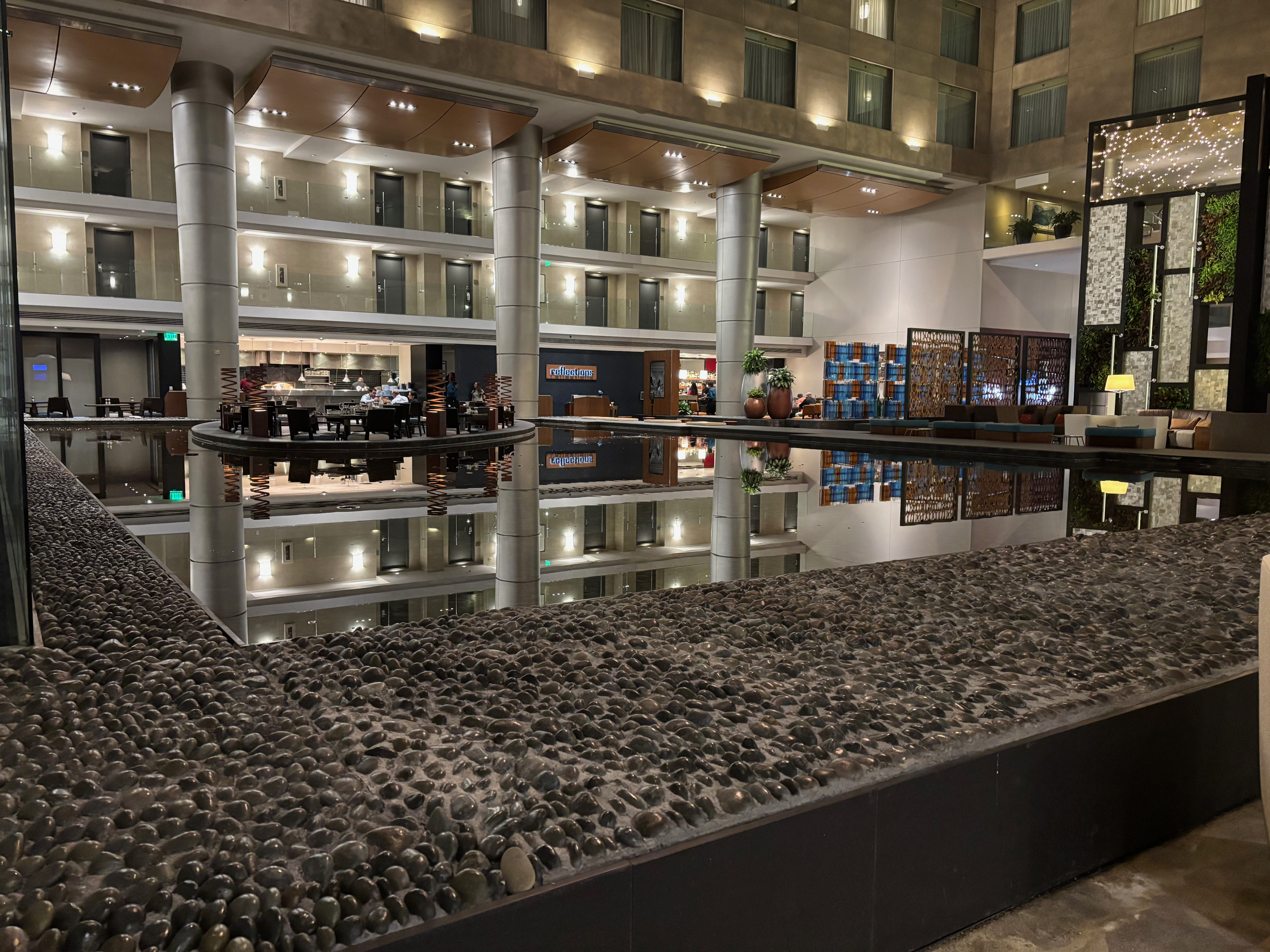 a large indoor pool with a large stone wall