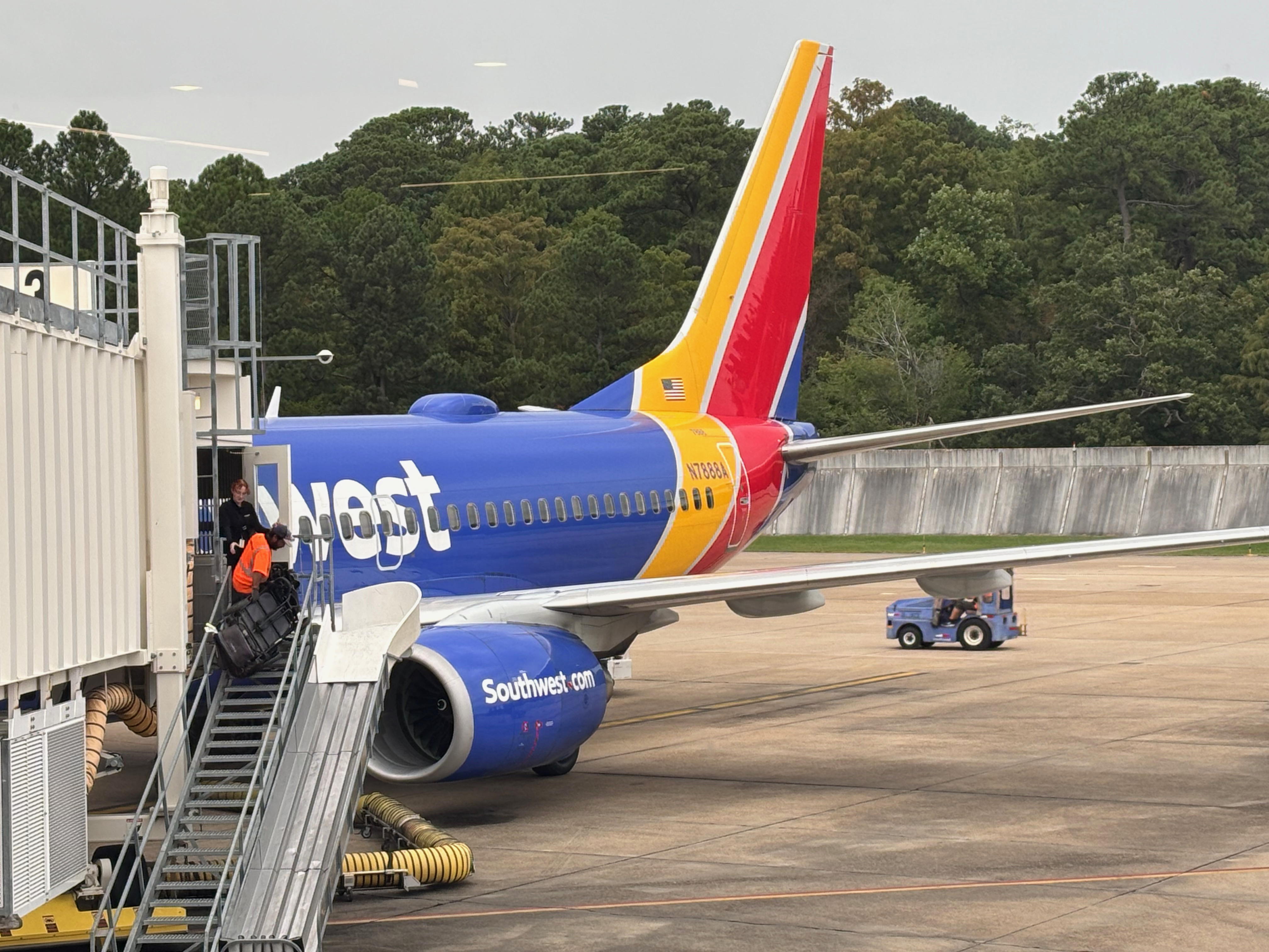 a blue and red airplane with a staircase