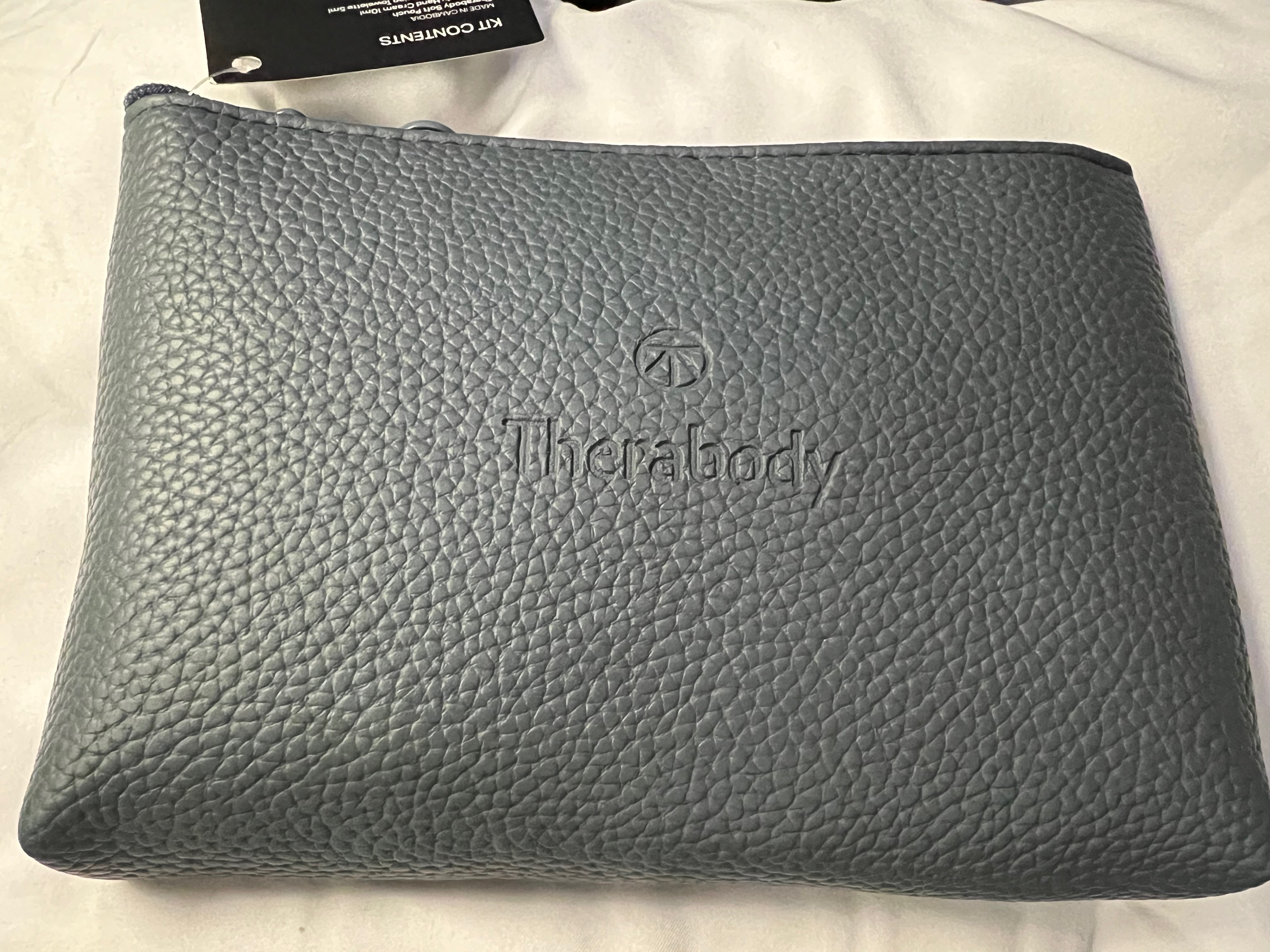 a grey leather pouch on a white surface
