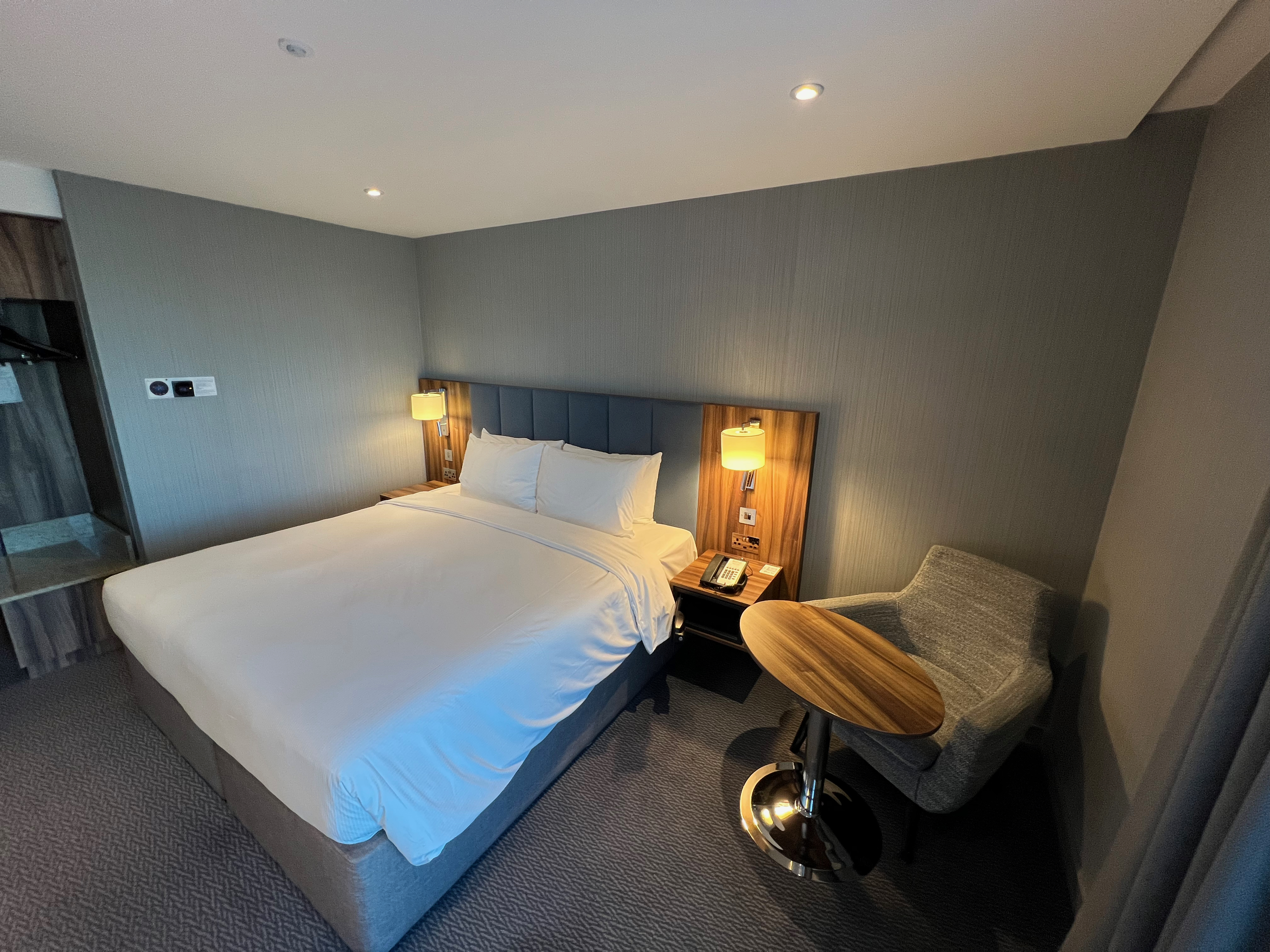 a bed with a table and chair in a room