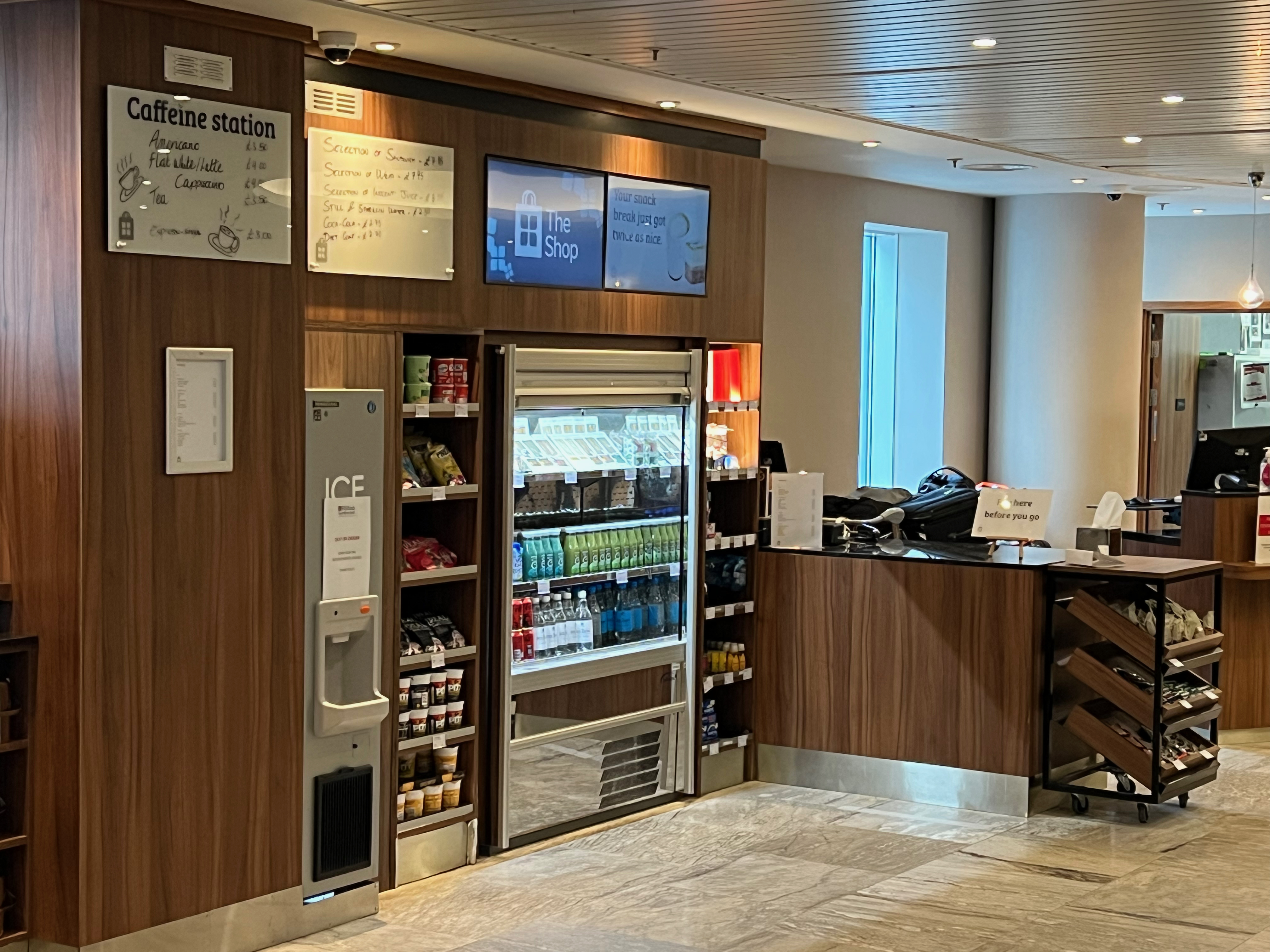 a coffee station with a counter and a sign