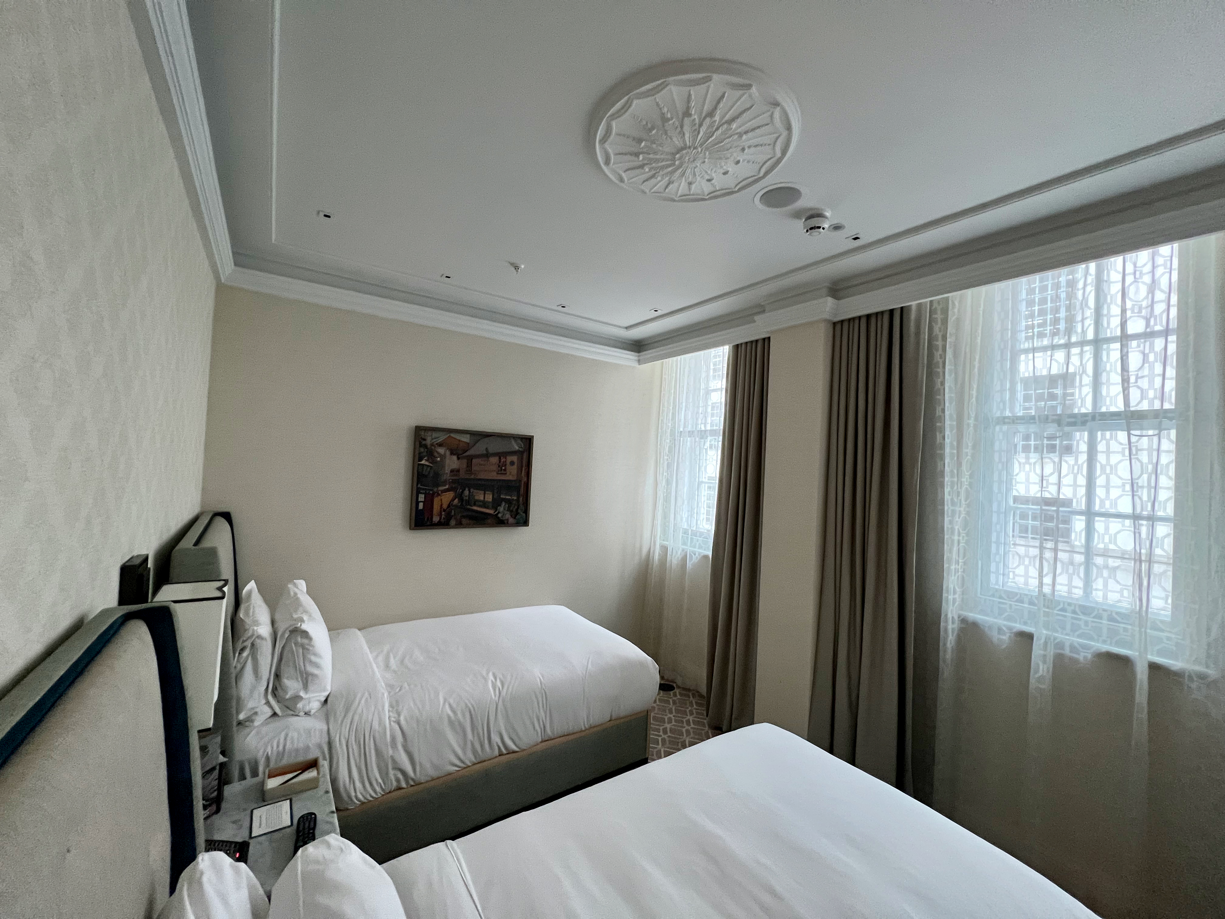a room with two beds and a window
