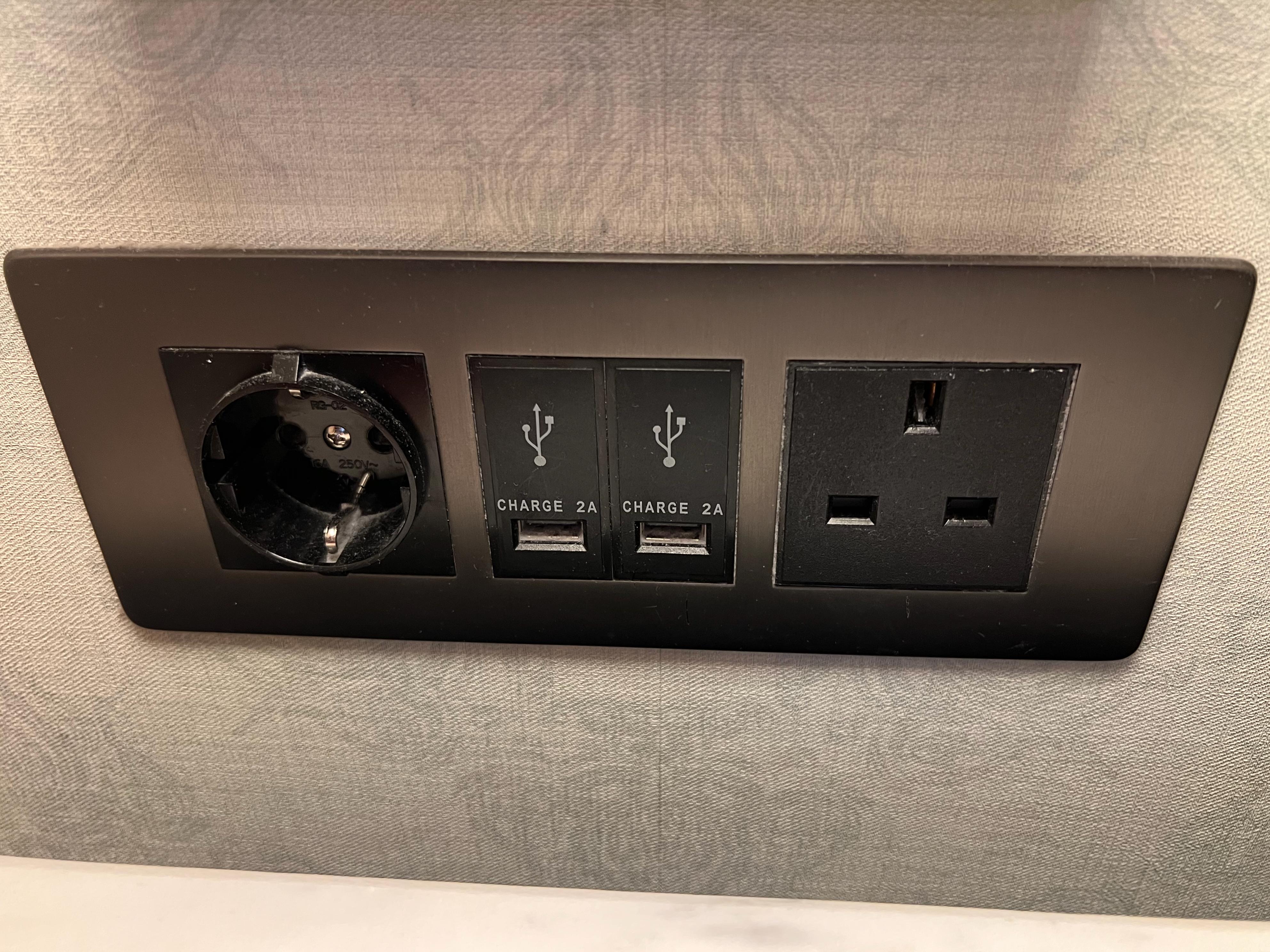a black electrical outlet with a black plug and a black rectangle
