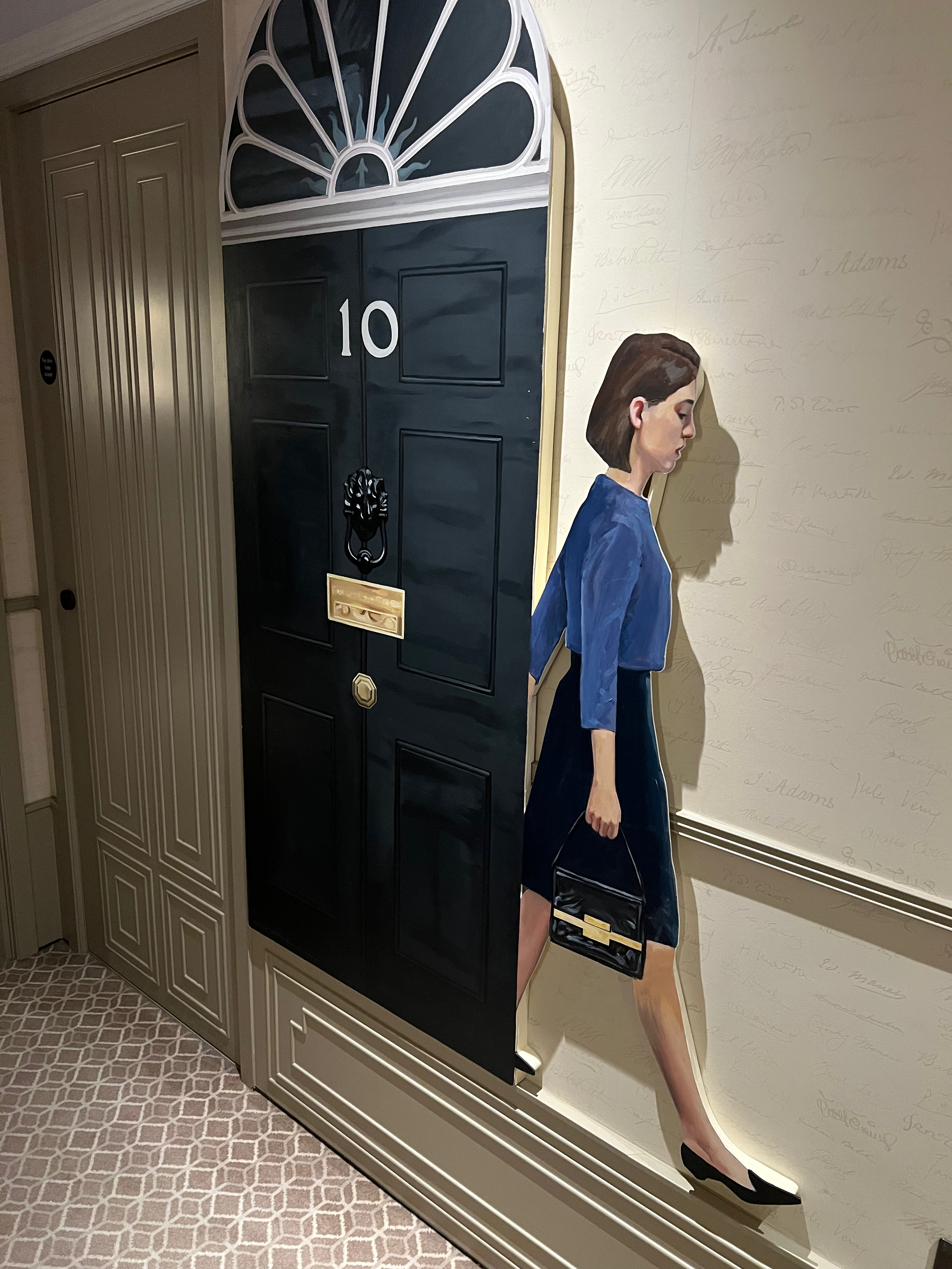 a cut out of a woman standing next to a door