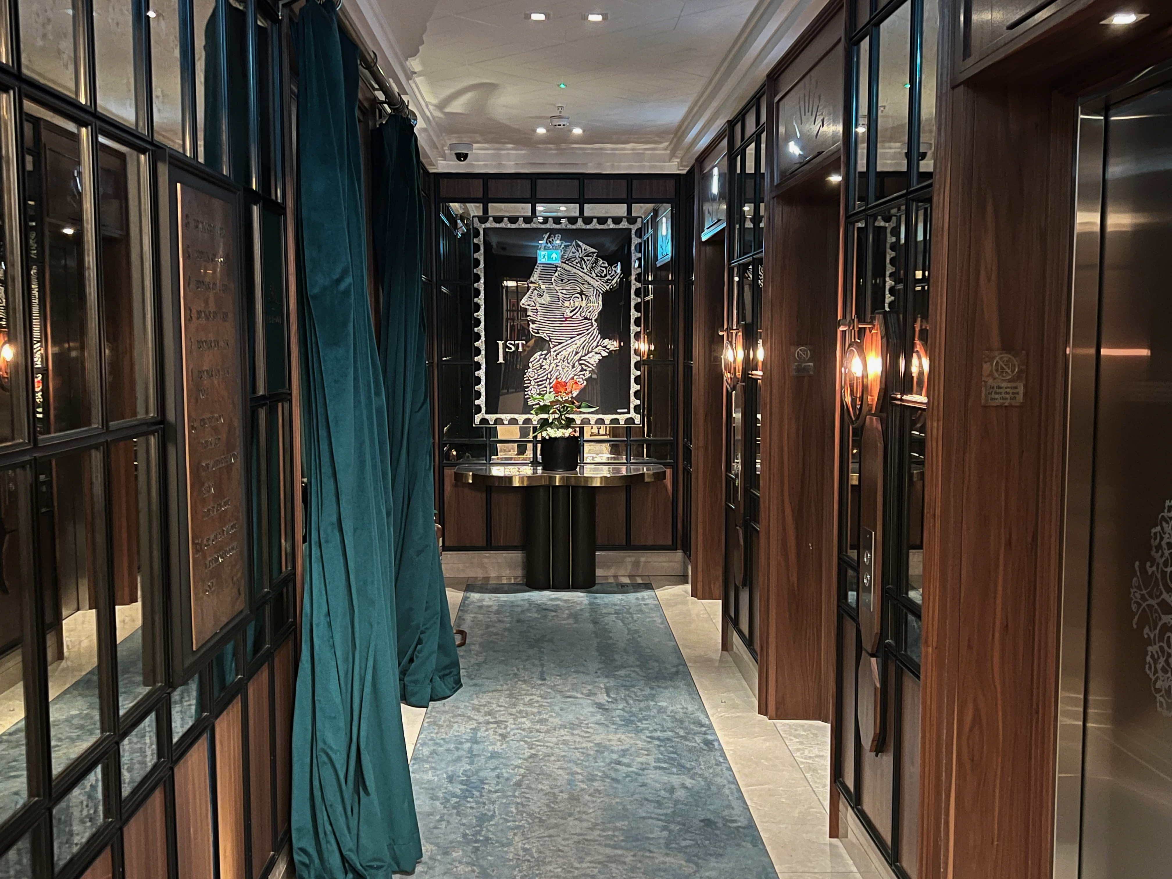 a hallway with blue curtains and a table