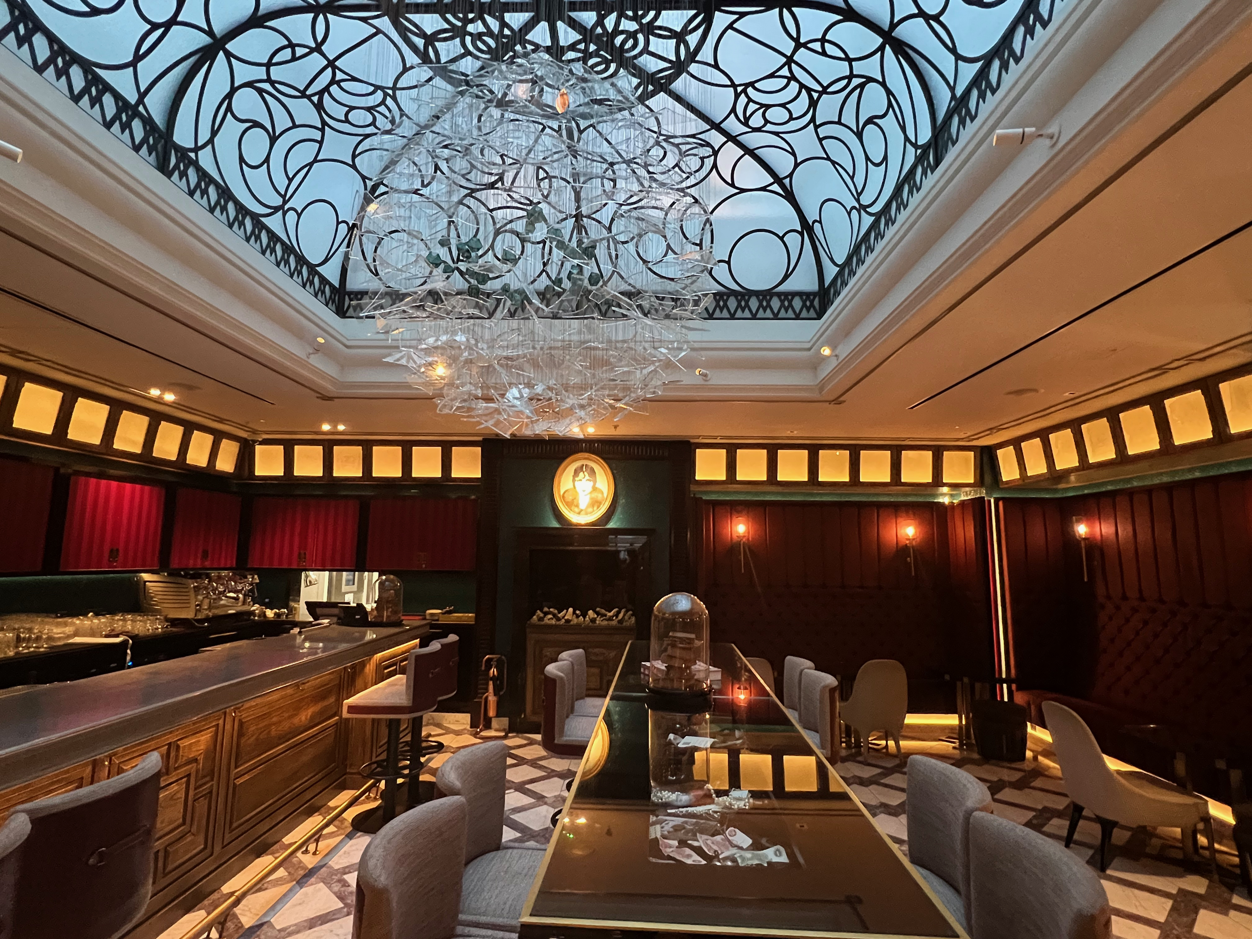 a room with a glass ceiling and a large chandelier