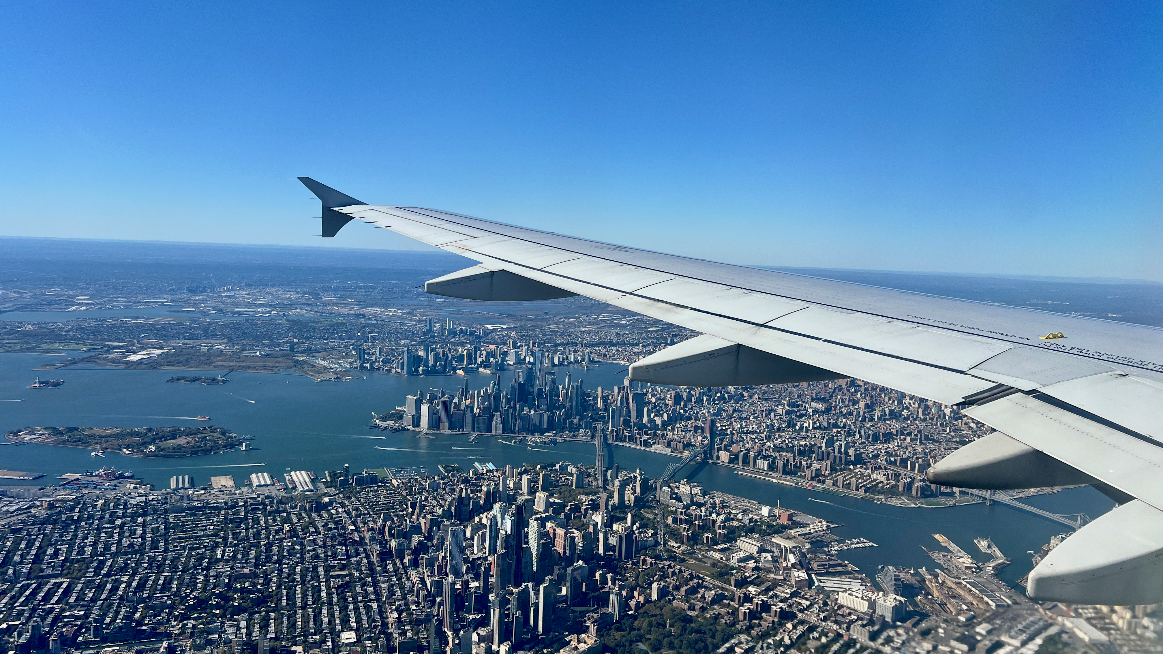 an airplane wing and city view from above