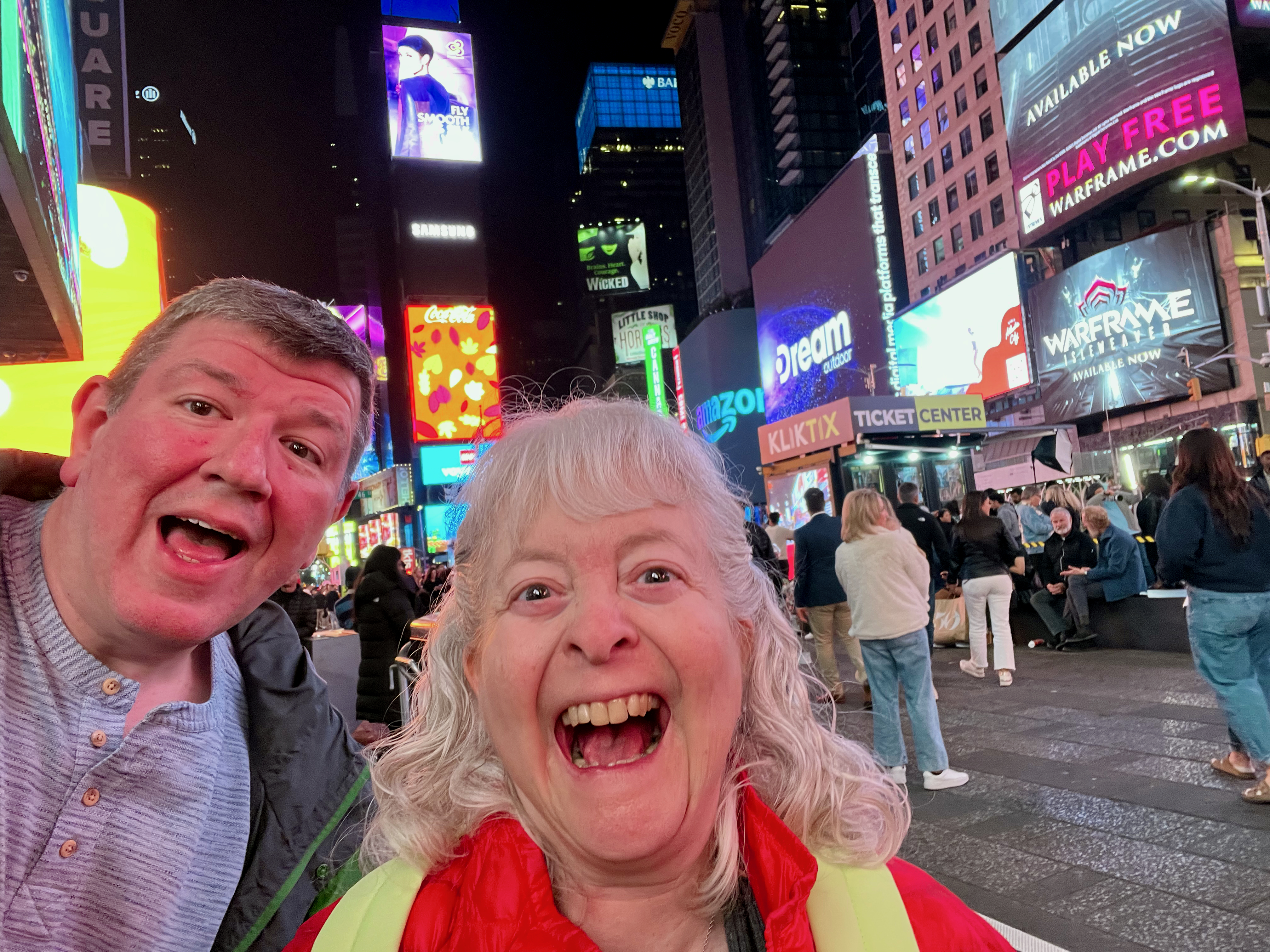 a man and woman taking a selfie in a city