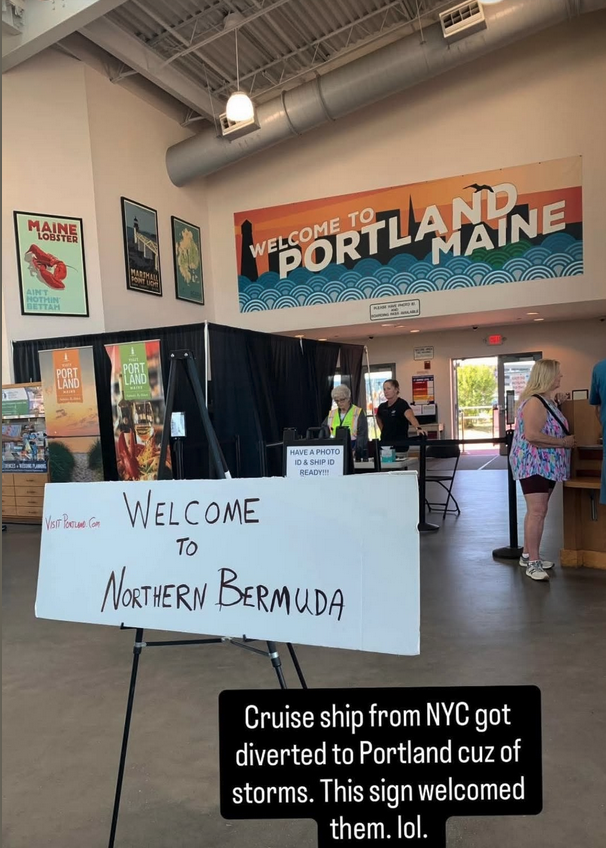 a group of people in a room with a sign