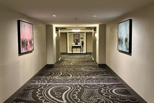 a hallway with art on the wall