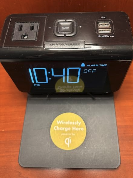 a black alarm clock on a table