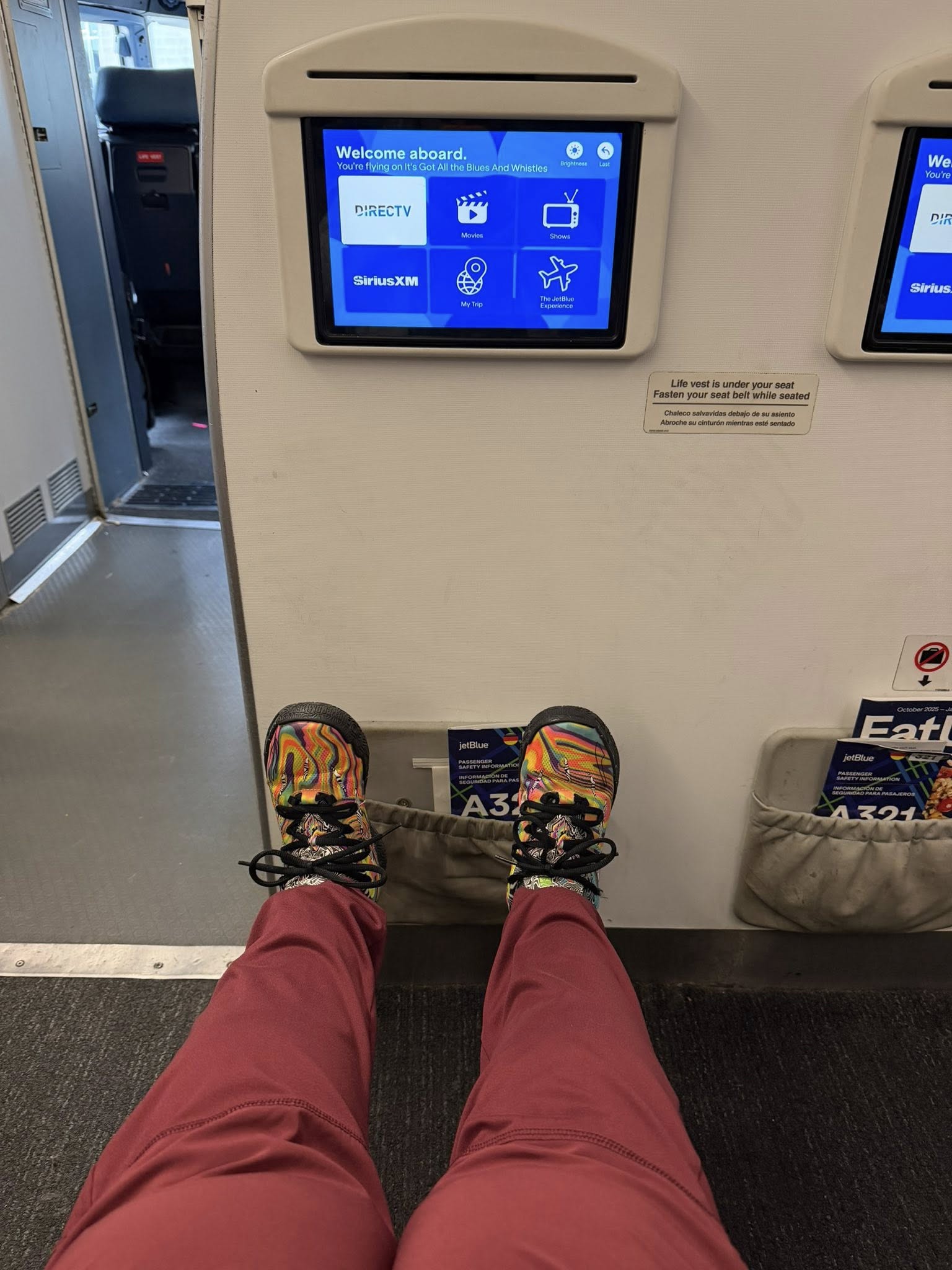 a person's legs and feet in front of a screen