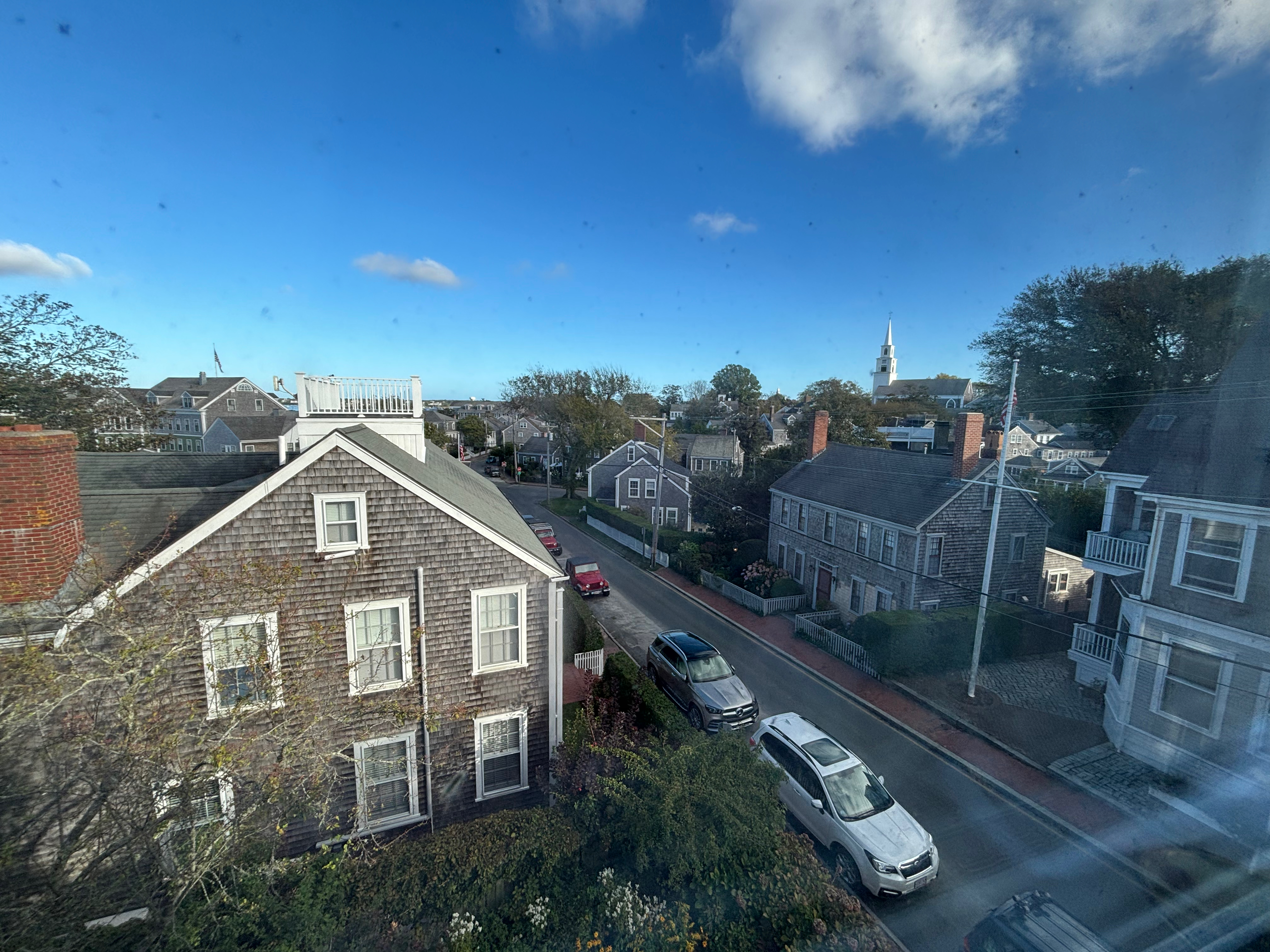 a view of a street and houses from a window