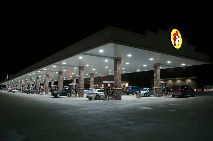 a gas station with cars parked at the top