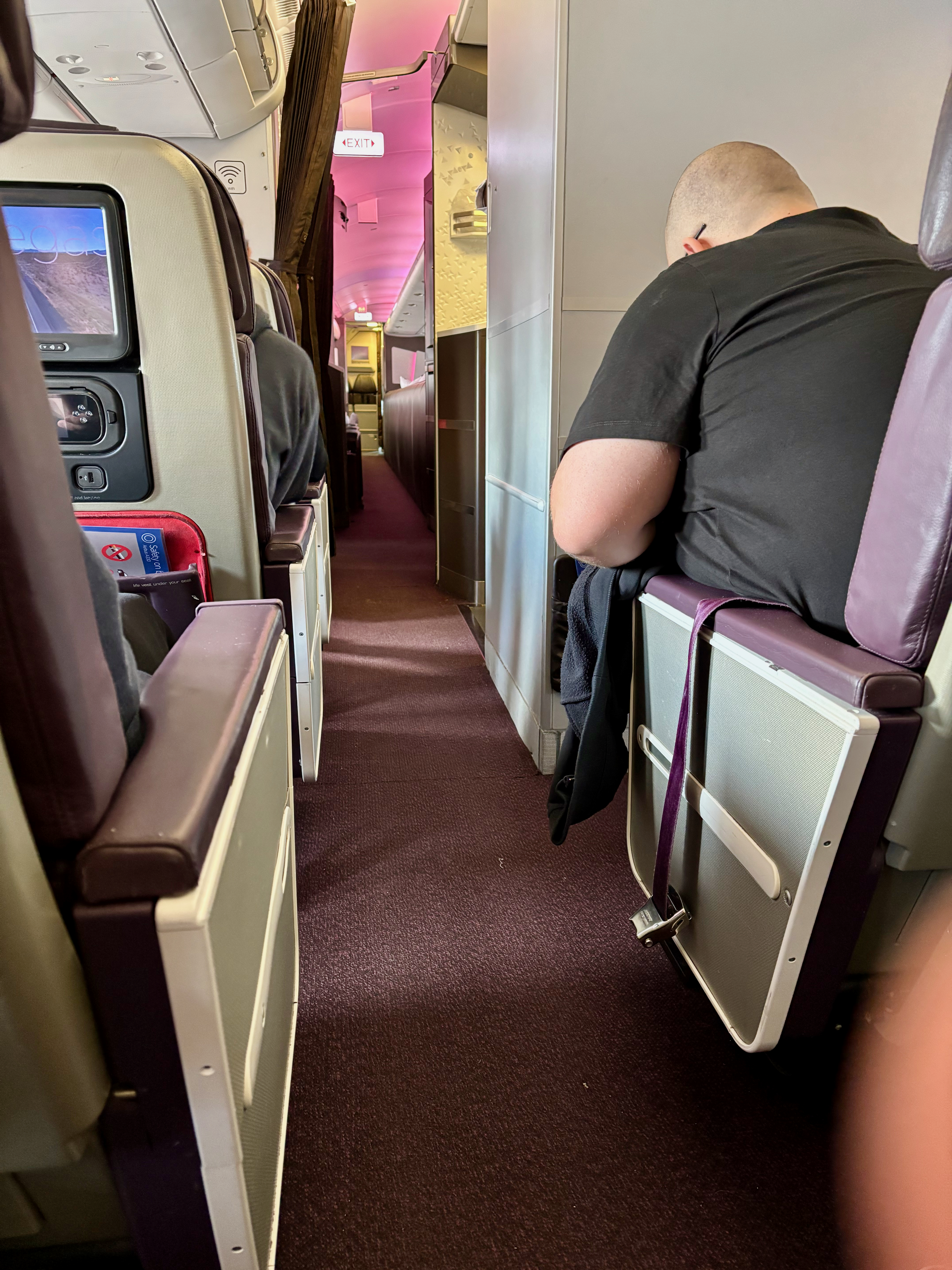 a man sleeping on a seat in an airplane