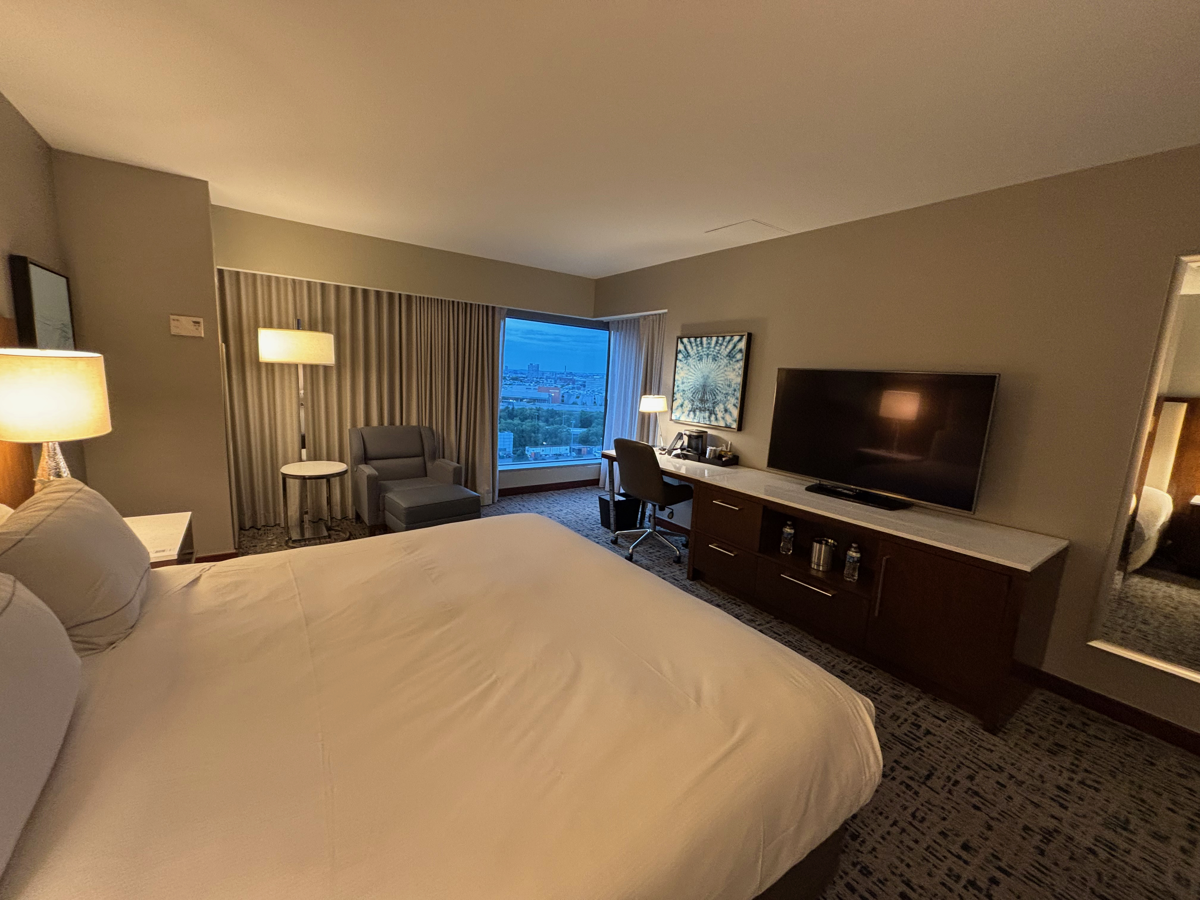 a room with a bed and a television