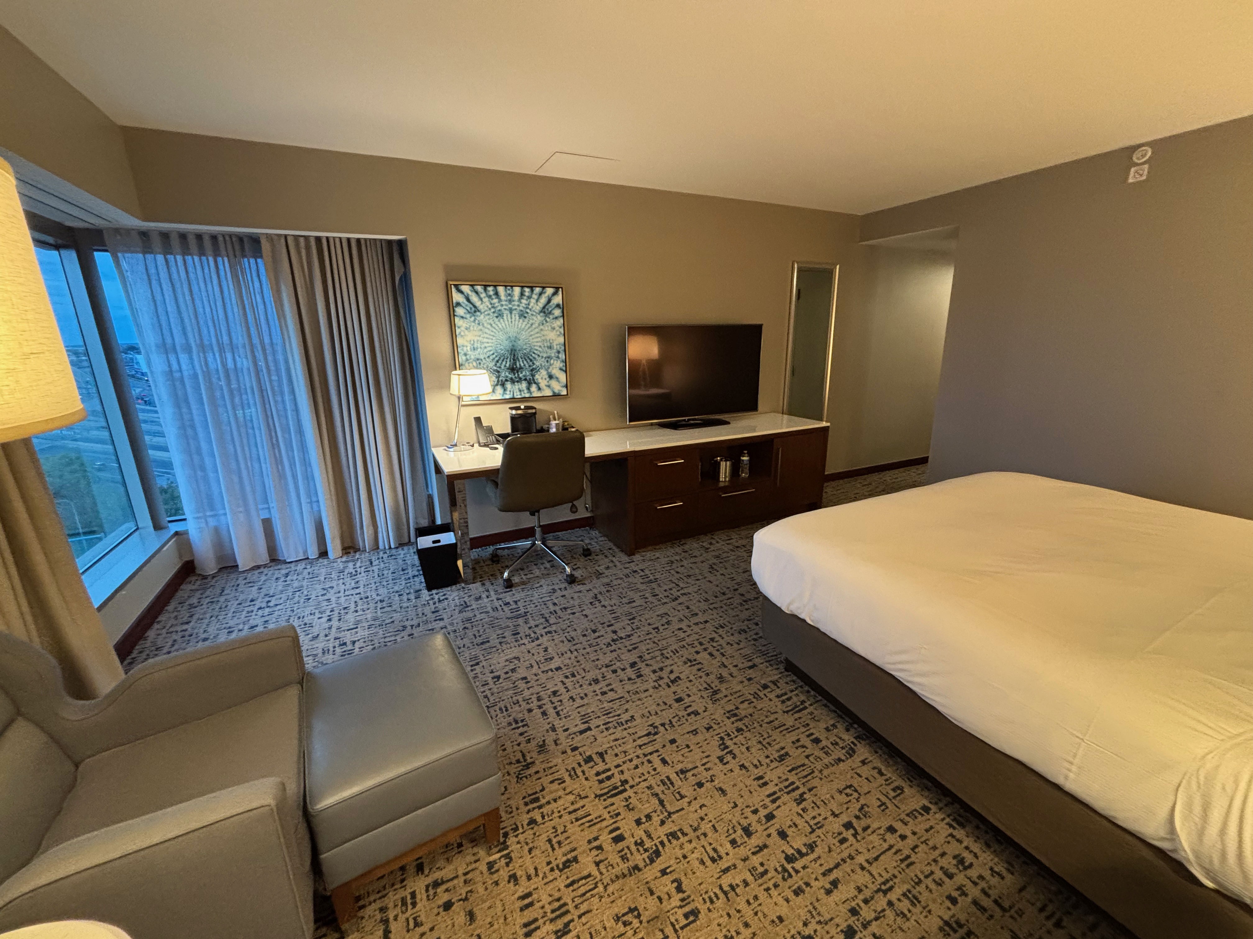 a room with a bed and a desk and chair