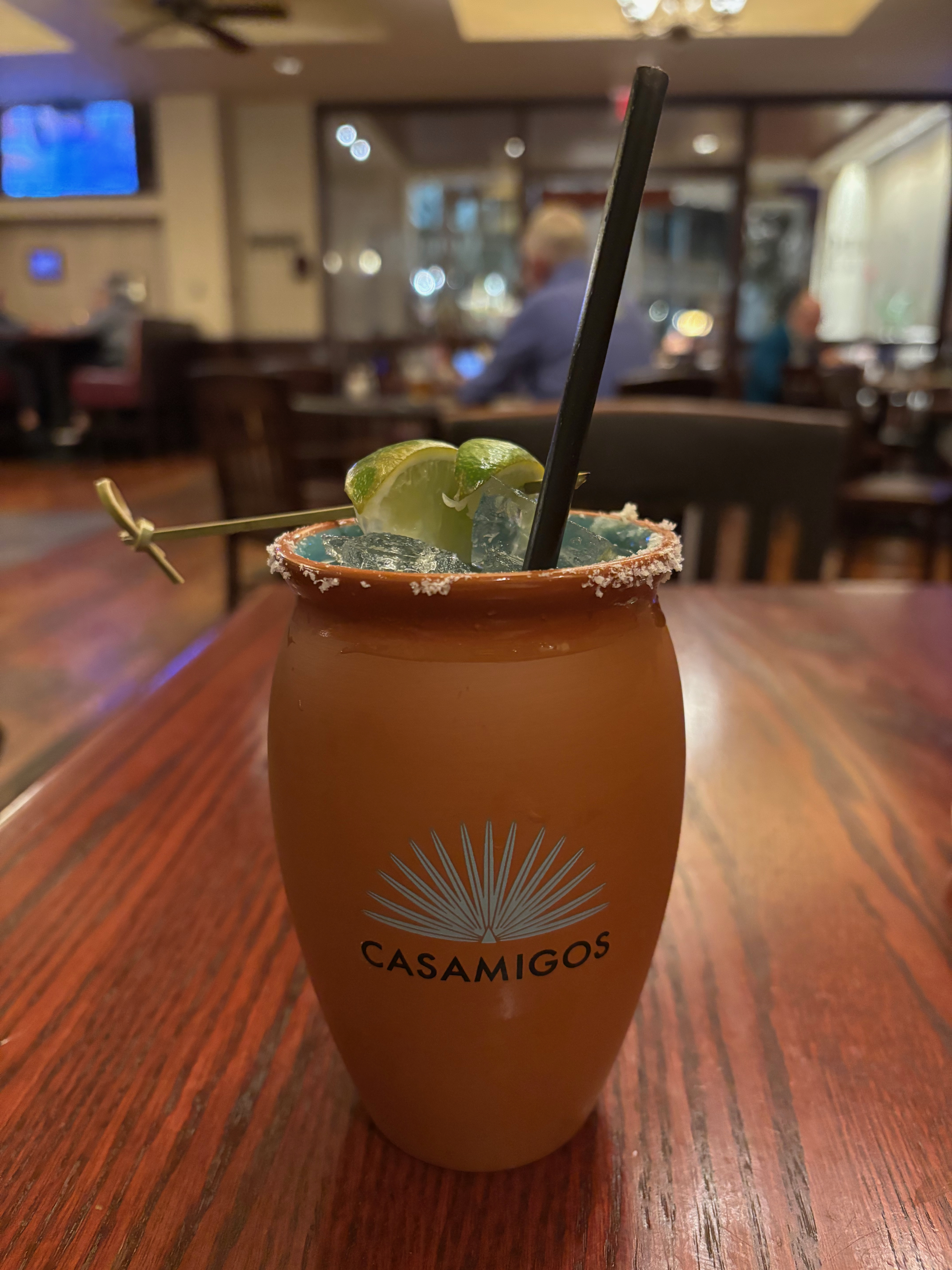 a brown cup with a straw and lime on it