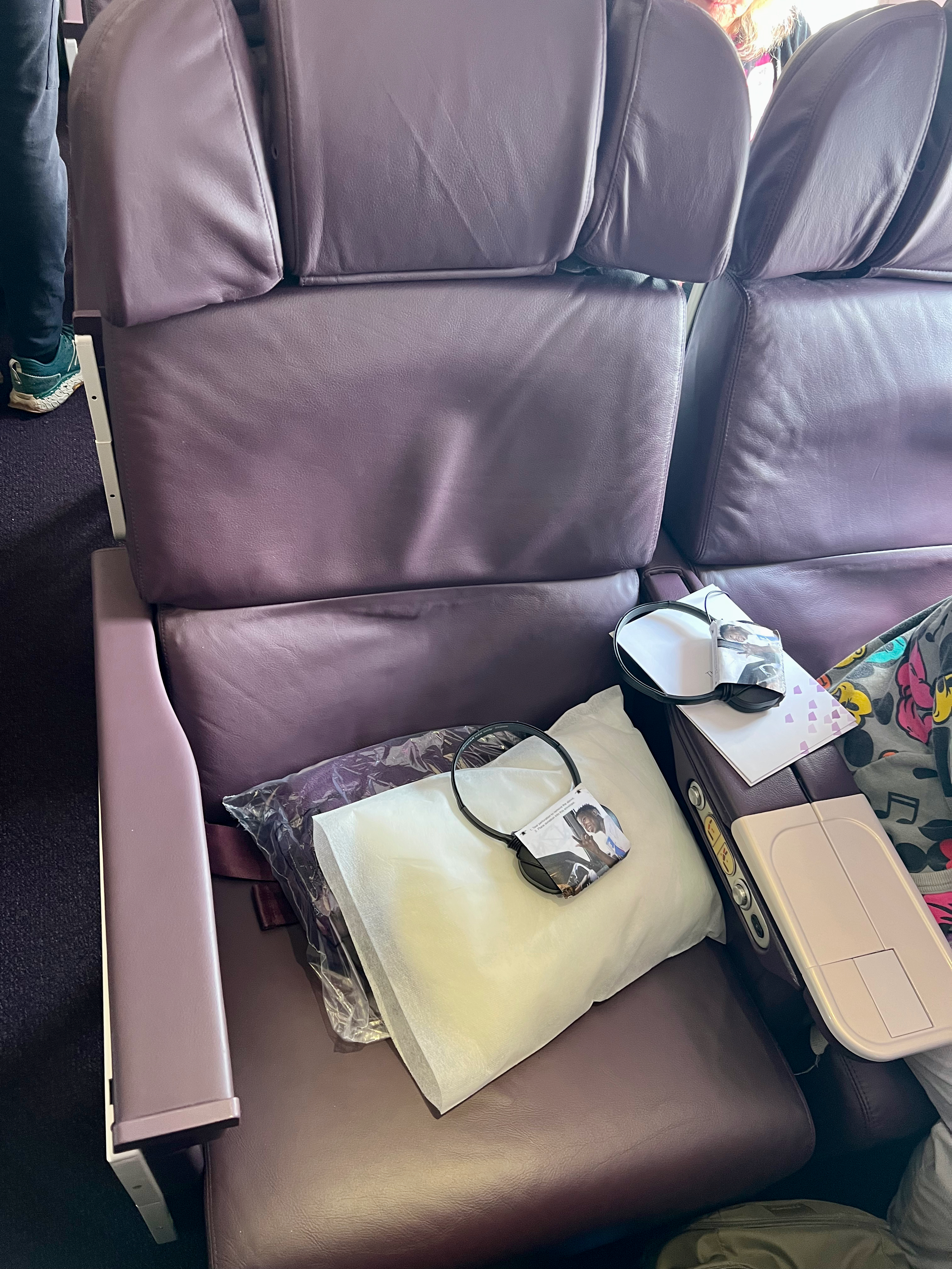 a seat with a bag and sunglasses on it