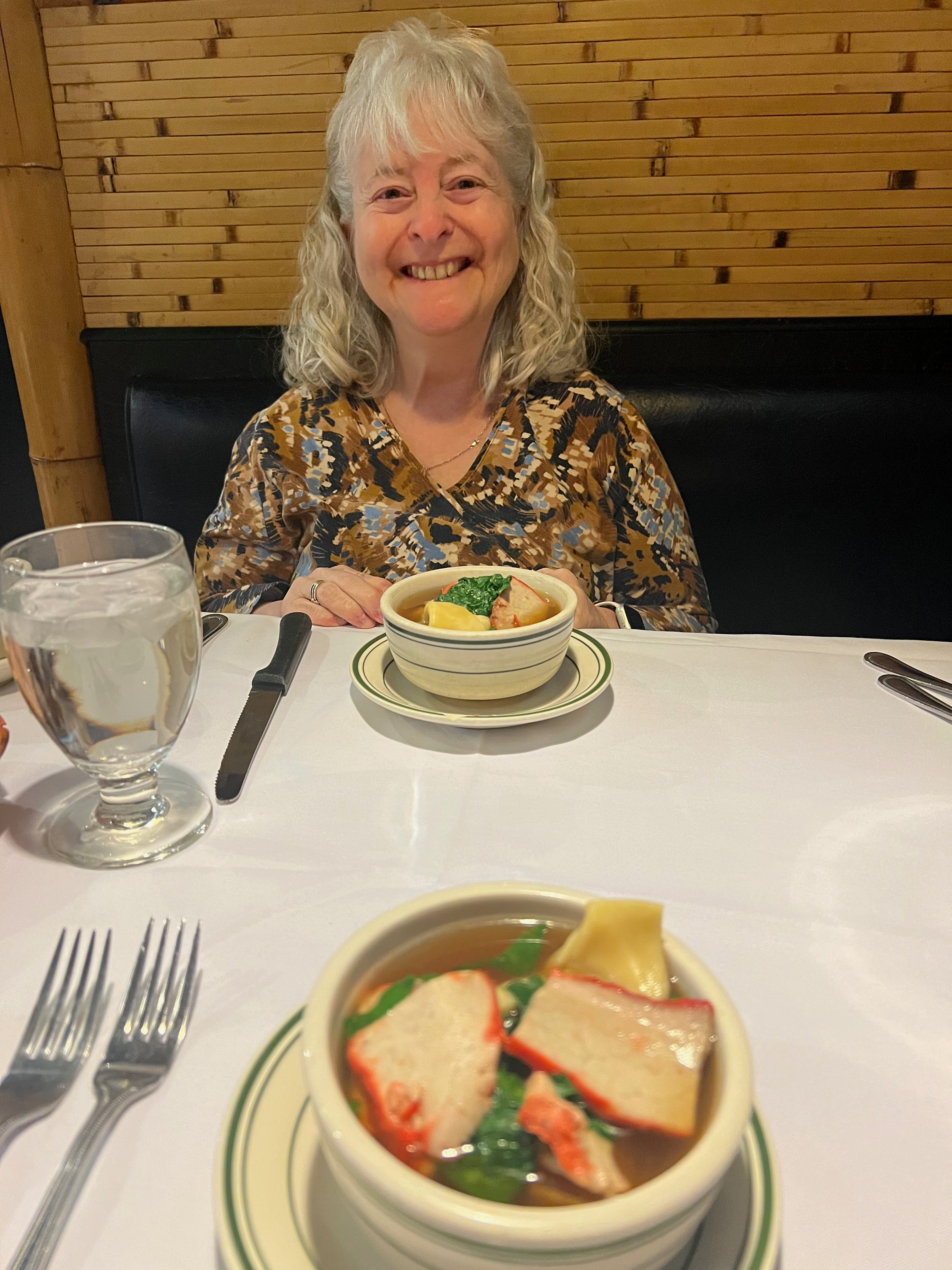 A bowl of wonton soup on the table