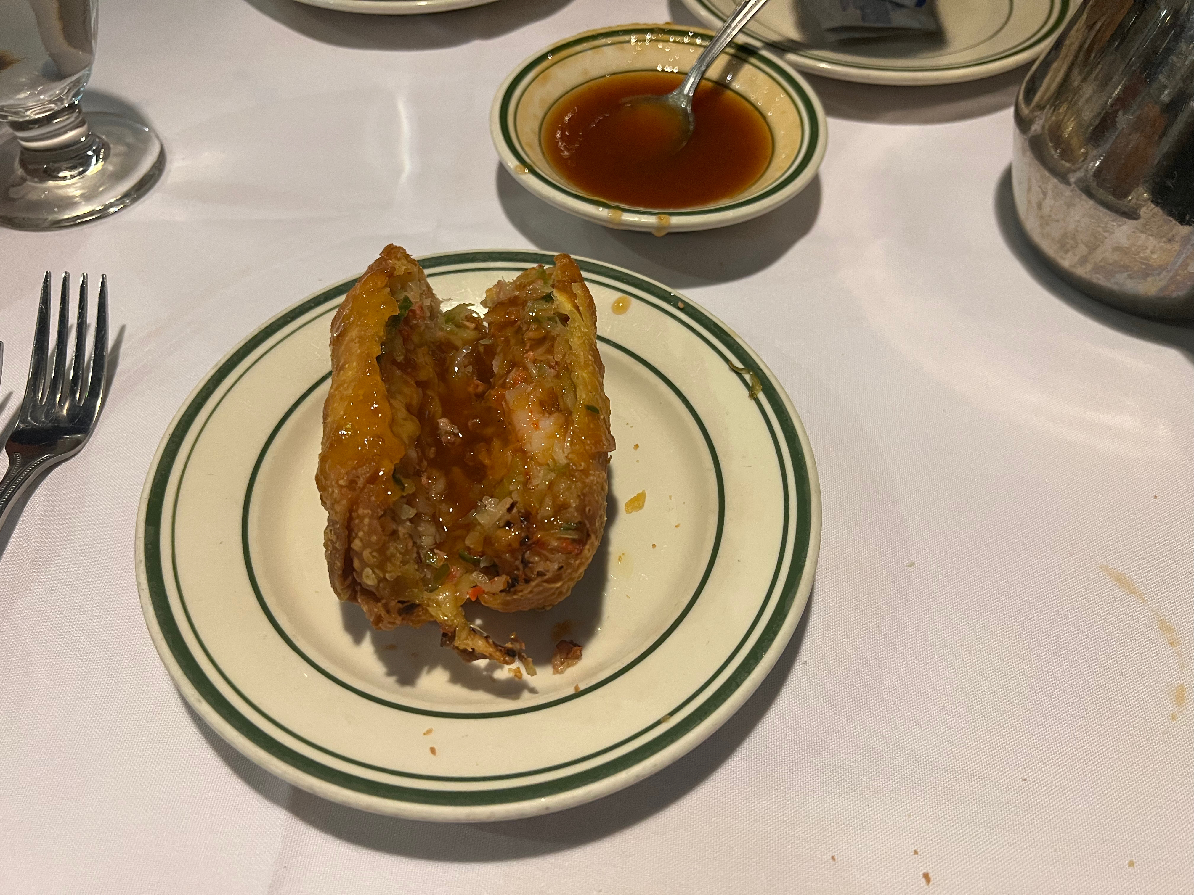 Egg roll on a plate with dipping sauce