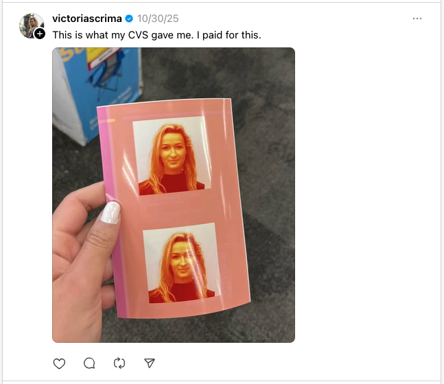 a hand holding a photo of a woman