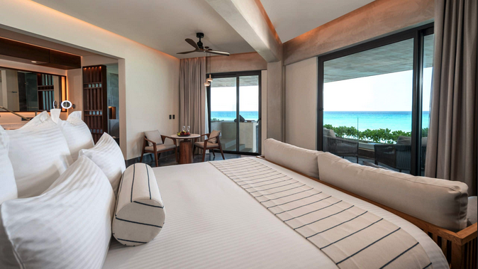 a room with a bed and a table and chairs